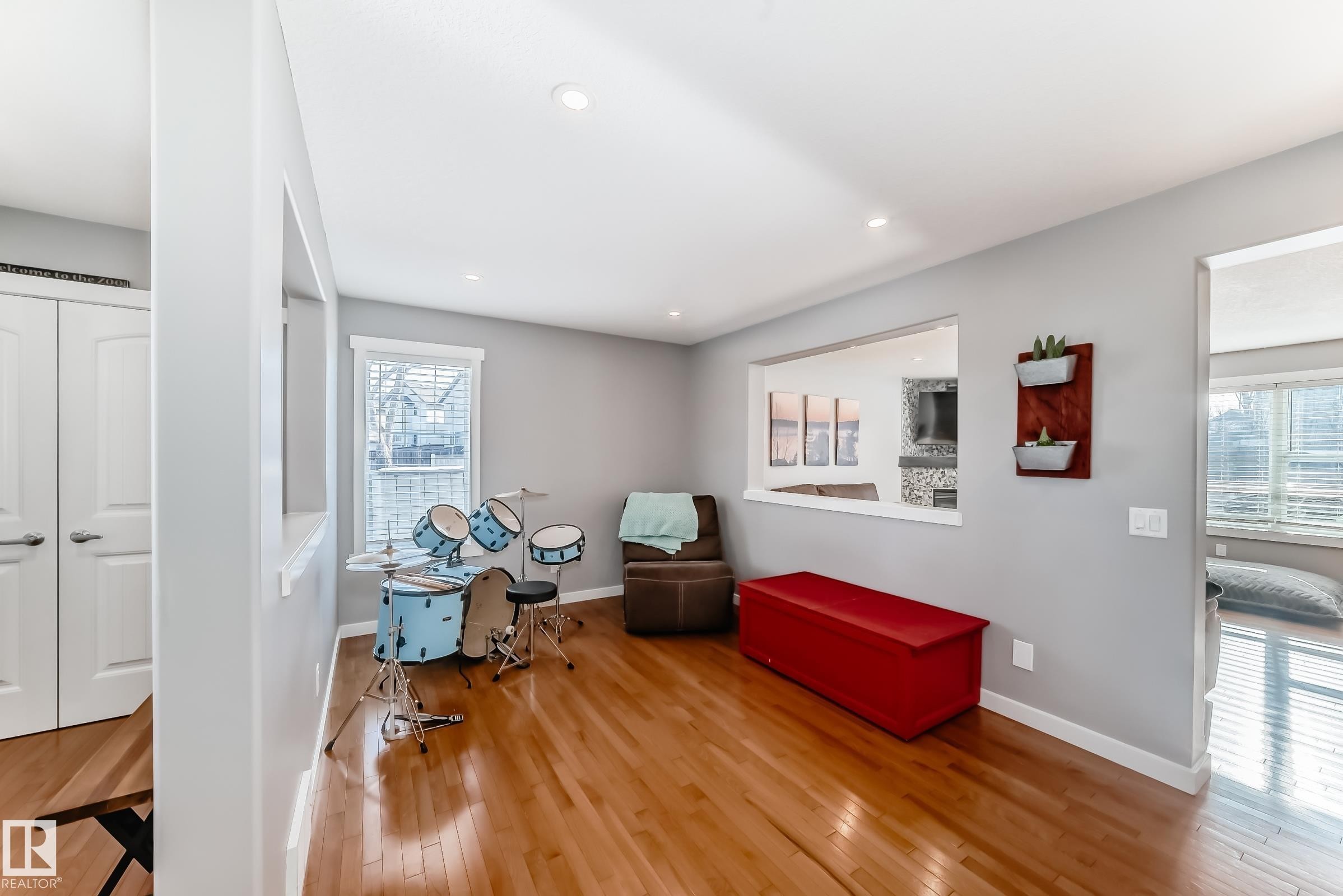 The interior features hardwood flooring, recessed lighting, and a light gray wall color - 6303 2 Avenue, Edmonton, AB - Indoor