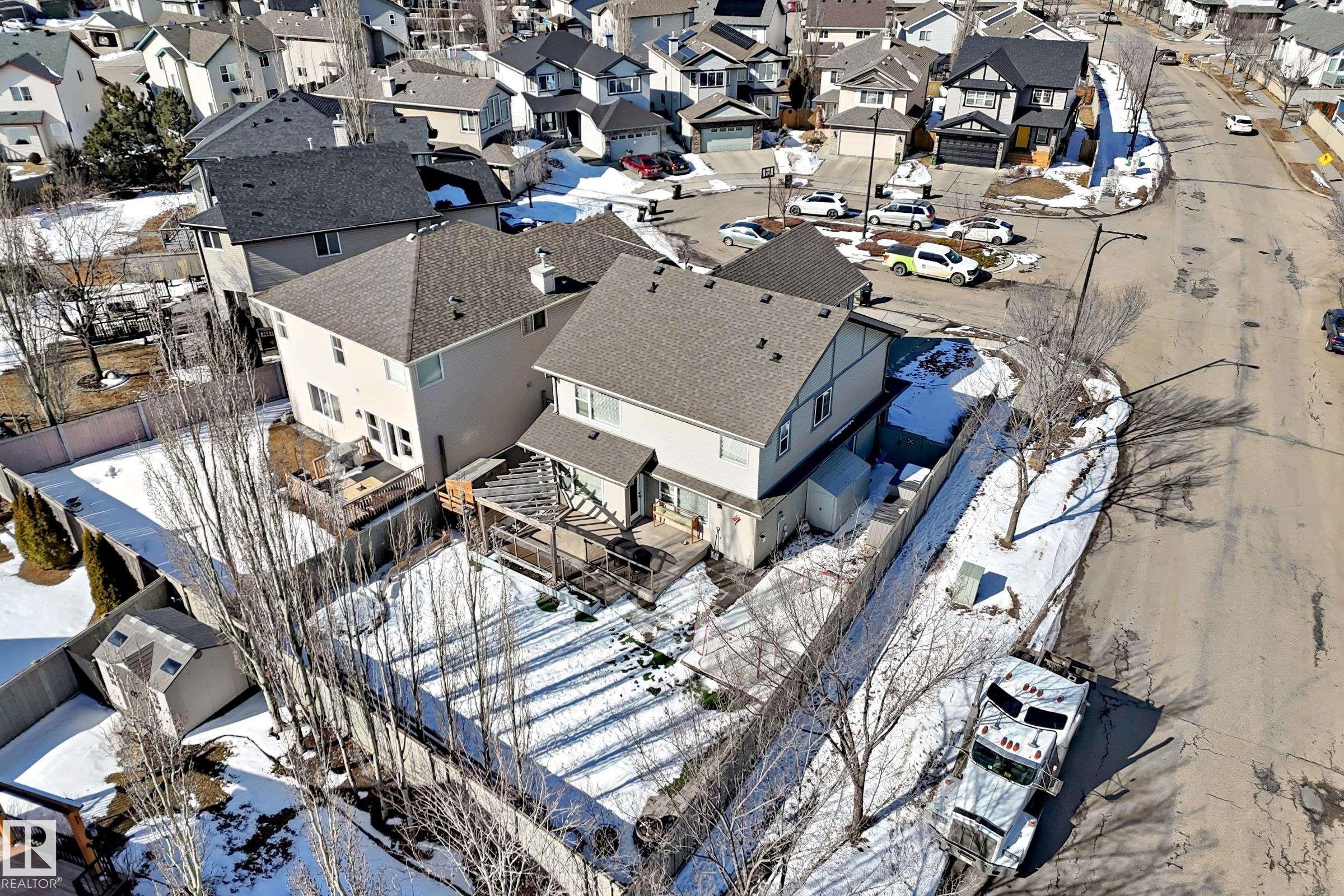 The property features an extensive backyard with a shed, a wooden deck, and a fenced perimeter - 6303 2 Avenue, Edmonton, AB - Outdoor