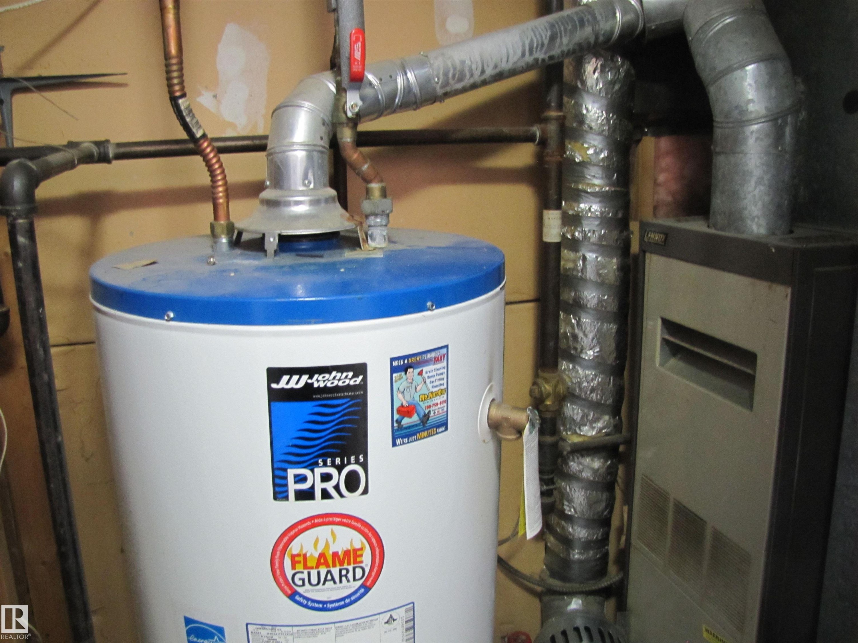 The property includes a water heater and furnace, with visible associated ductwork and piping - 3617 43A Avenue, Edmonton, AB - Indoor Photo Showing Basement