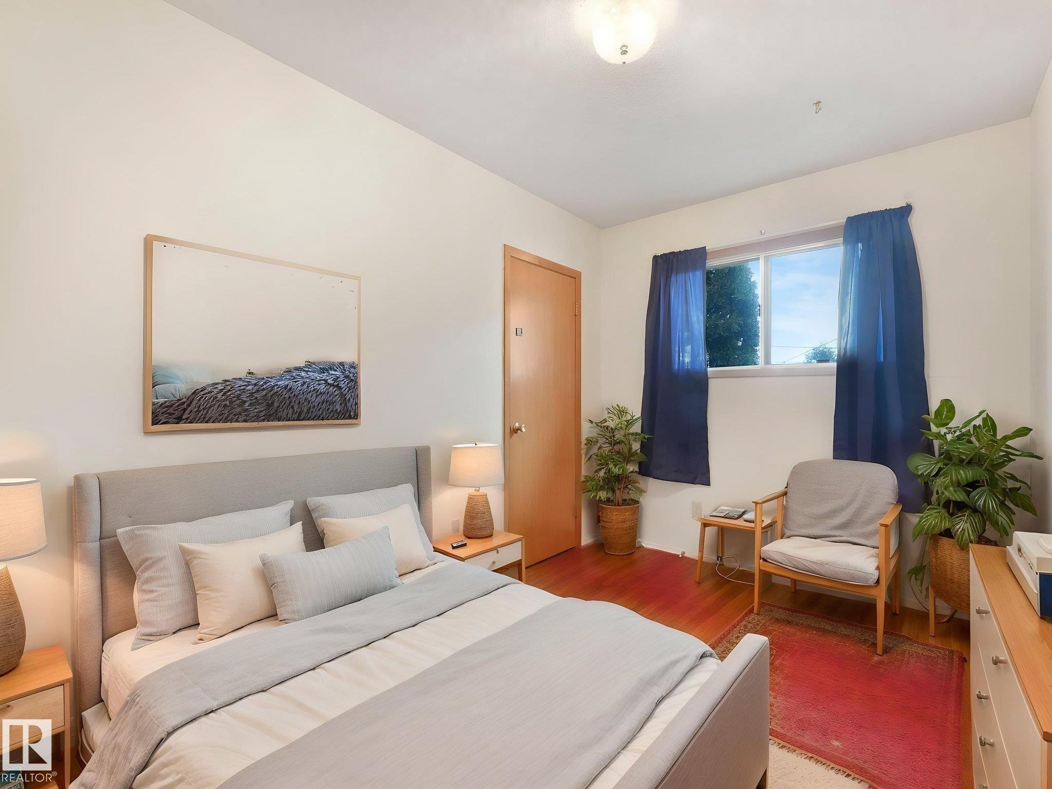 This room features hardwood flooring, a window providing natural light, and a light-colored ceiling - 5904 84 Avenue, Edmonton, AB - Indoor Photo Showing Bedroom