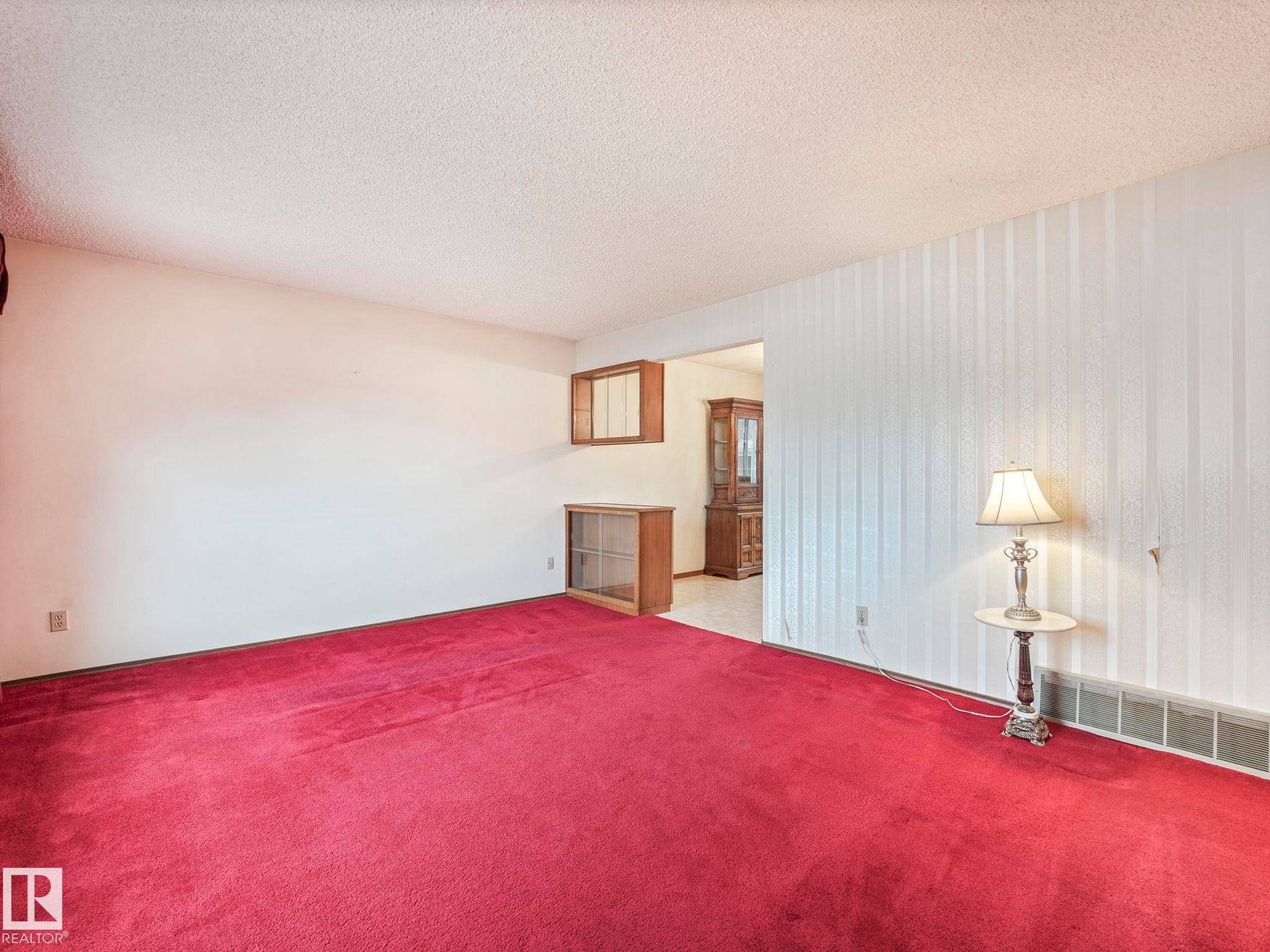 Living room featuring red carpet flooring and white walls - 5904 84 Avenue, Edmonton, AB - Indoor Photo Showing Bedroom