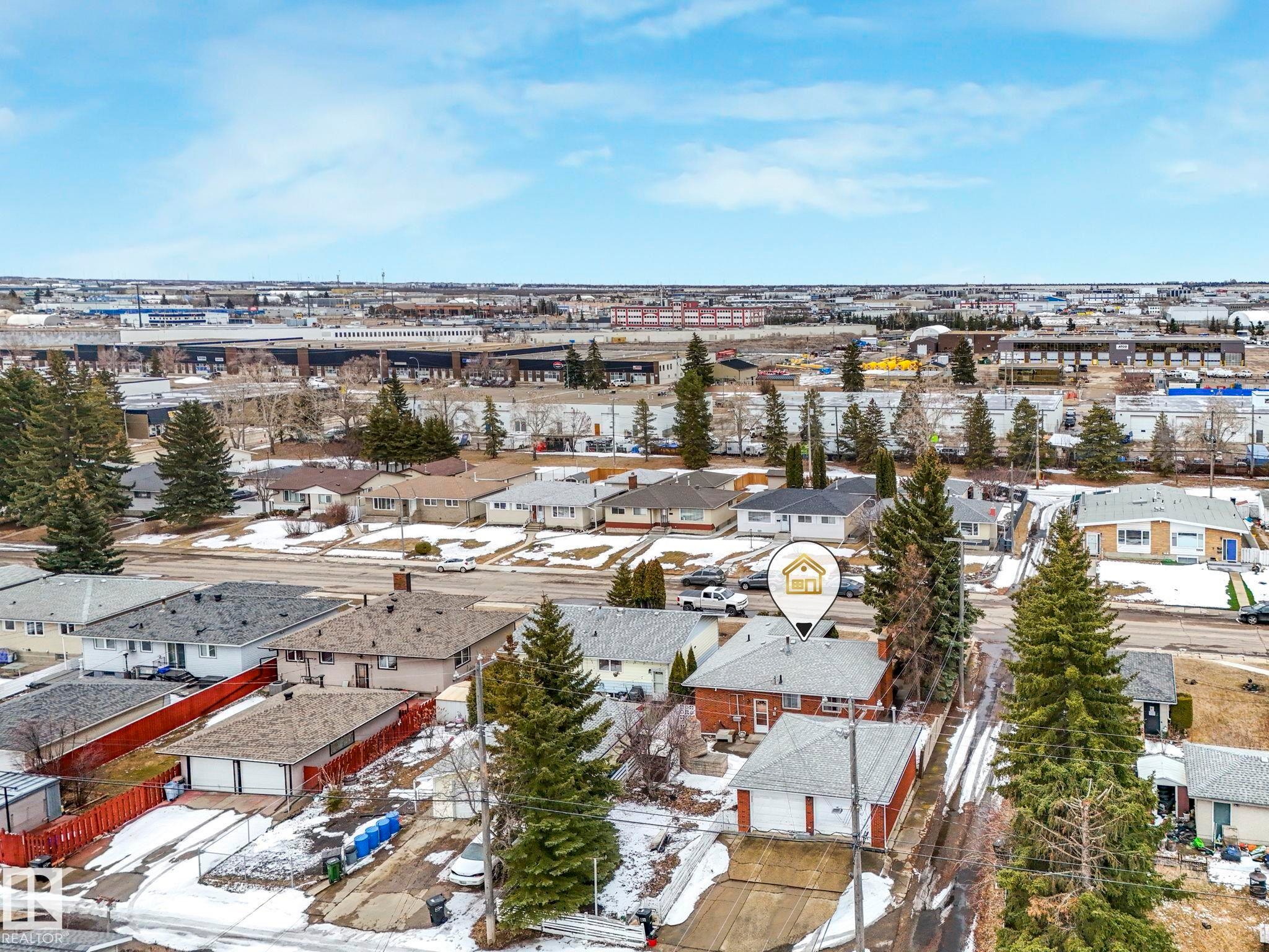 An aerial view of the property and its surrounding neighborhood, featuring residential homes, mature trees, and visible roads - 5904 84 Avenue, Edmonton, AB - Outdoor With View