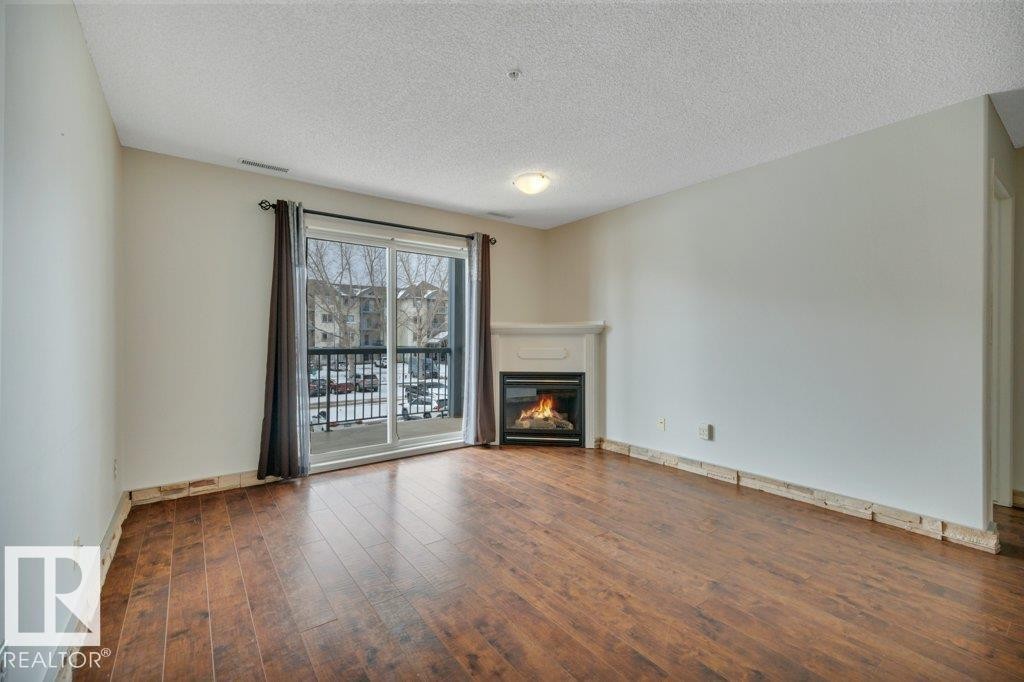 242 16311 95 Street, Edmonton, AB - Indoor Photo Showing Living Room With Fireplace