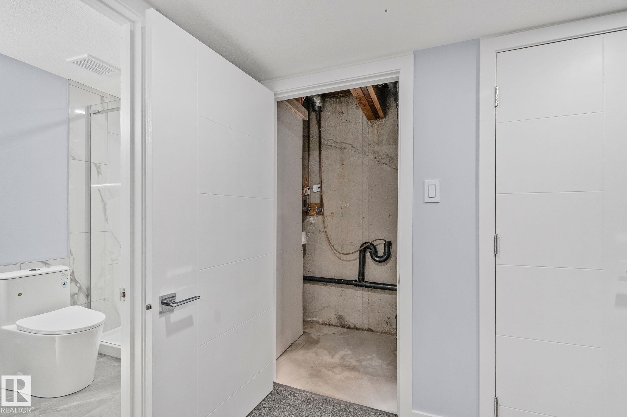 This property features a bathroom with a white toilet and a shower with glass enclosure, visible through an open door - 8620 38A Avenue, Edmonton, AB - Indoor