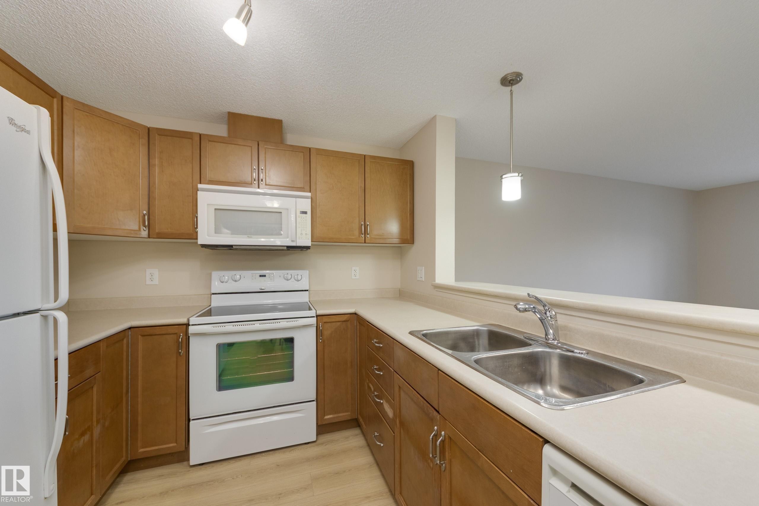 404 6070 Schonsee Way, Edmonton, AB - Indoor Photo Showing Kitchen With Double Sink