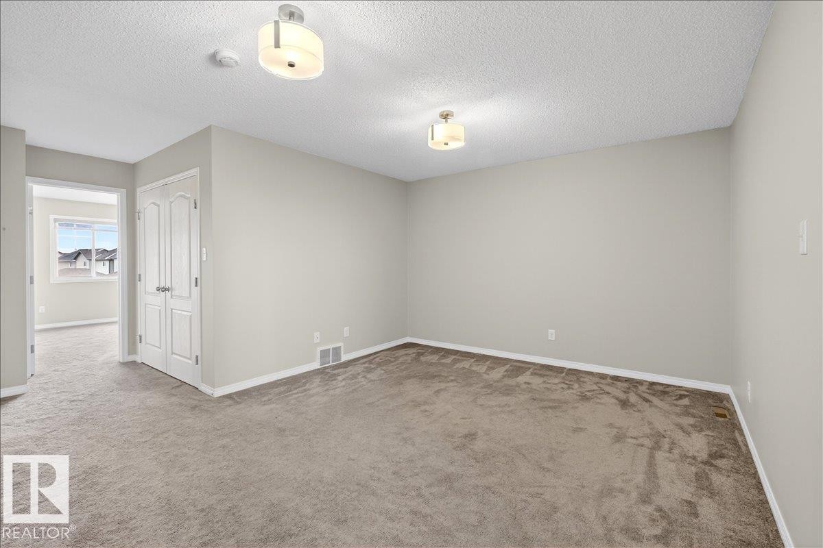 Upstairs bonus room, private area for the family. This versatile space features carpeting, neutral wall tones, and recessed lighting. - 17023 38 Street Nw, Edmonton, AB - Indoor Photo Showing Other Room