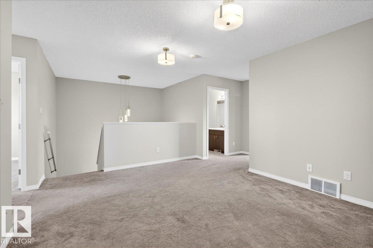 Upstairs bonus room, private area for the family. This versatile space features carpeting, neutral wall tones, and recessed lighting - 17023 38 Street Nw, Edmonton, AB - Indoor Photo Showing Other Room