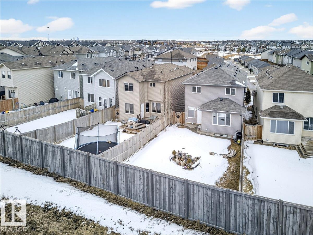 The property features a fenced yard with a patio area and a detached structure with a window - 17023 38 Street Nw, Edmonton, AB - Outdoor
