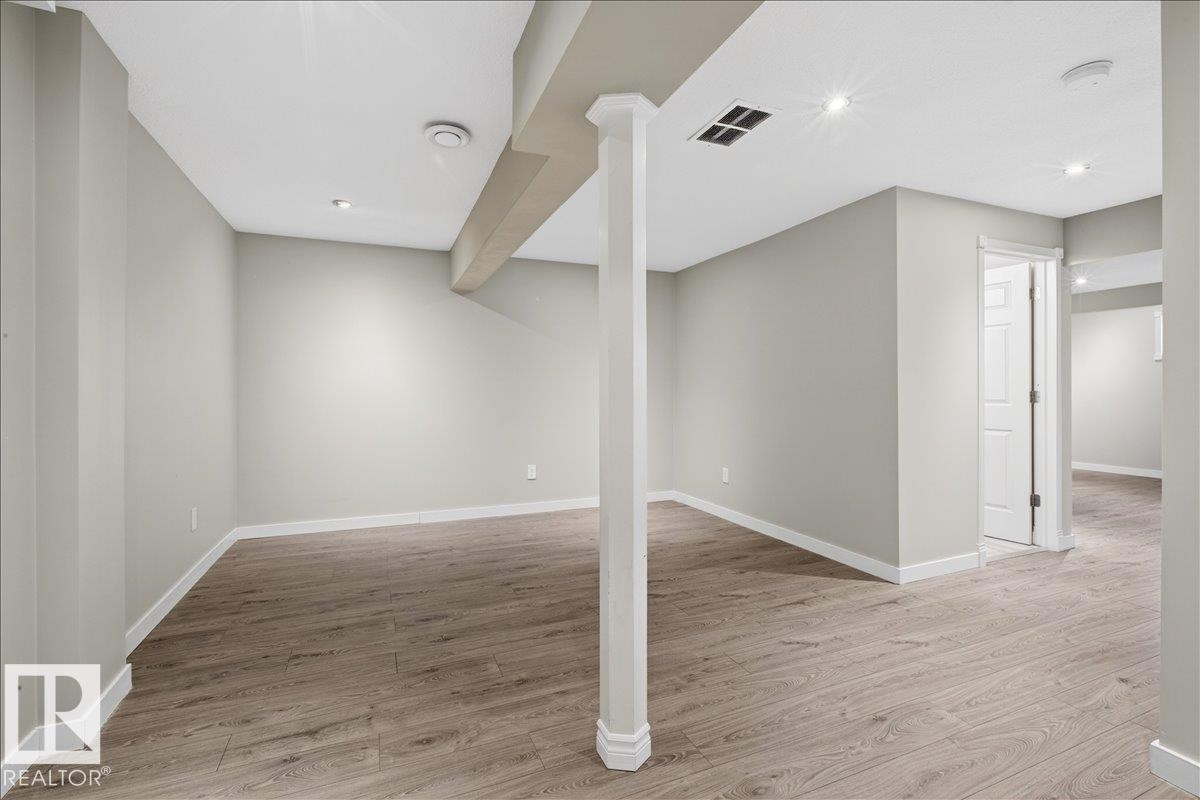 Spacious area featuring light-toned flooring, recessed lighting, and a neutral wall color - 17023 38 Street Nw, Edmonton, AB - Indoor Photo Showing Other Room