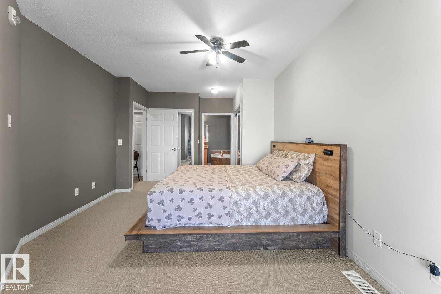 The property features a bedroom with carpeted flooring and a ceiling fan - 107 801 11 Street, Cold Lake, AB - Indoor Photo Showing Bedroom
