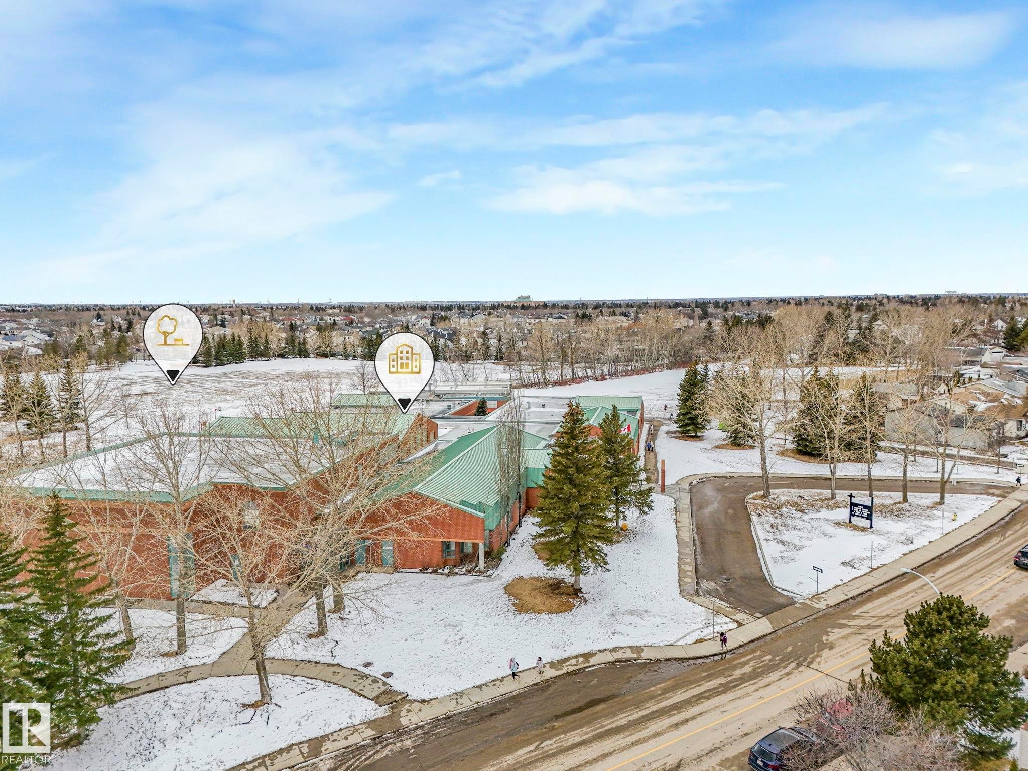 Aerial view of the neighborhood showcasing a large building with a green roof, surrounded by trees and snow-covered ground - 4105 41 Avenue, Edmonton, AB - Outdoor With View
