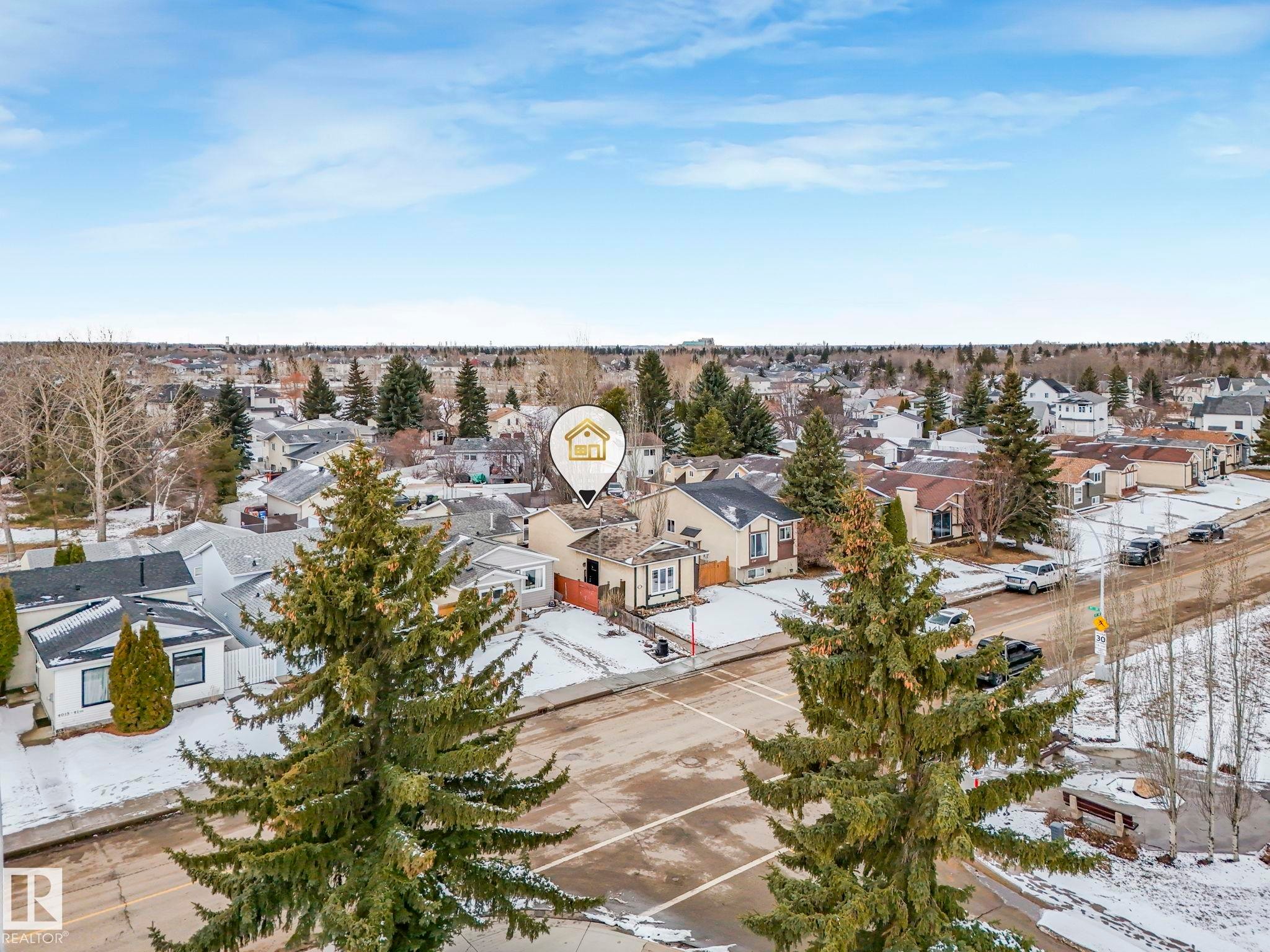 An aerial view showcases the property within a neighborhood featuring diverse architectural styles and mature trees - 4105 41 Avenue, Edmonton, AB - Outdoor With View