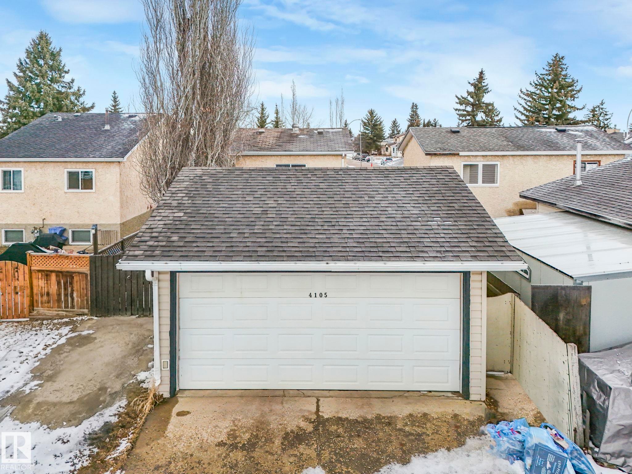 Detached garage with a shingled roof and a white overhead door - 4105 41 Avenue, Edmonton, AB - Outdoor With Exterior