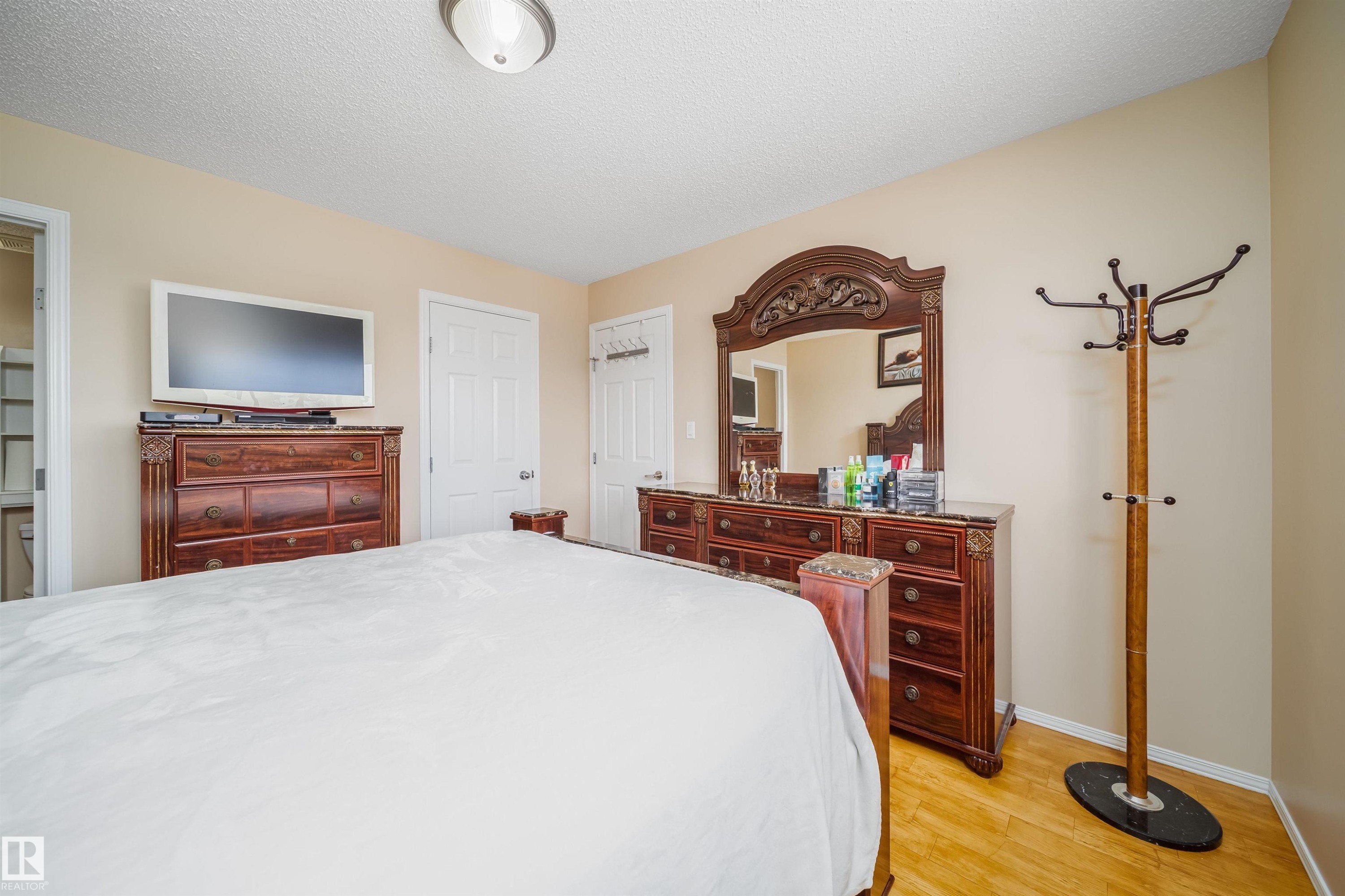 The property features light-colored walls and wood flooring, enhancing the spacious feel of the room - 8932 175 Avenue, Edmonton, AB - Indoor Photo Showing Bedroom