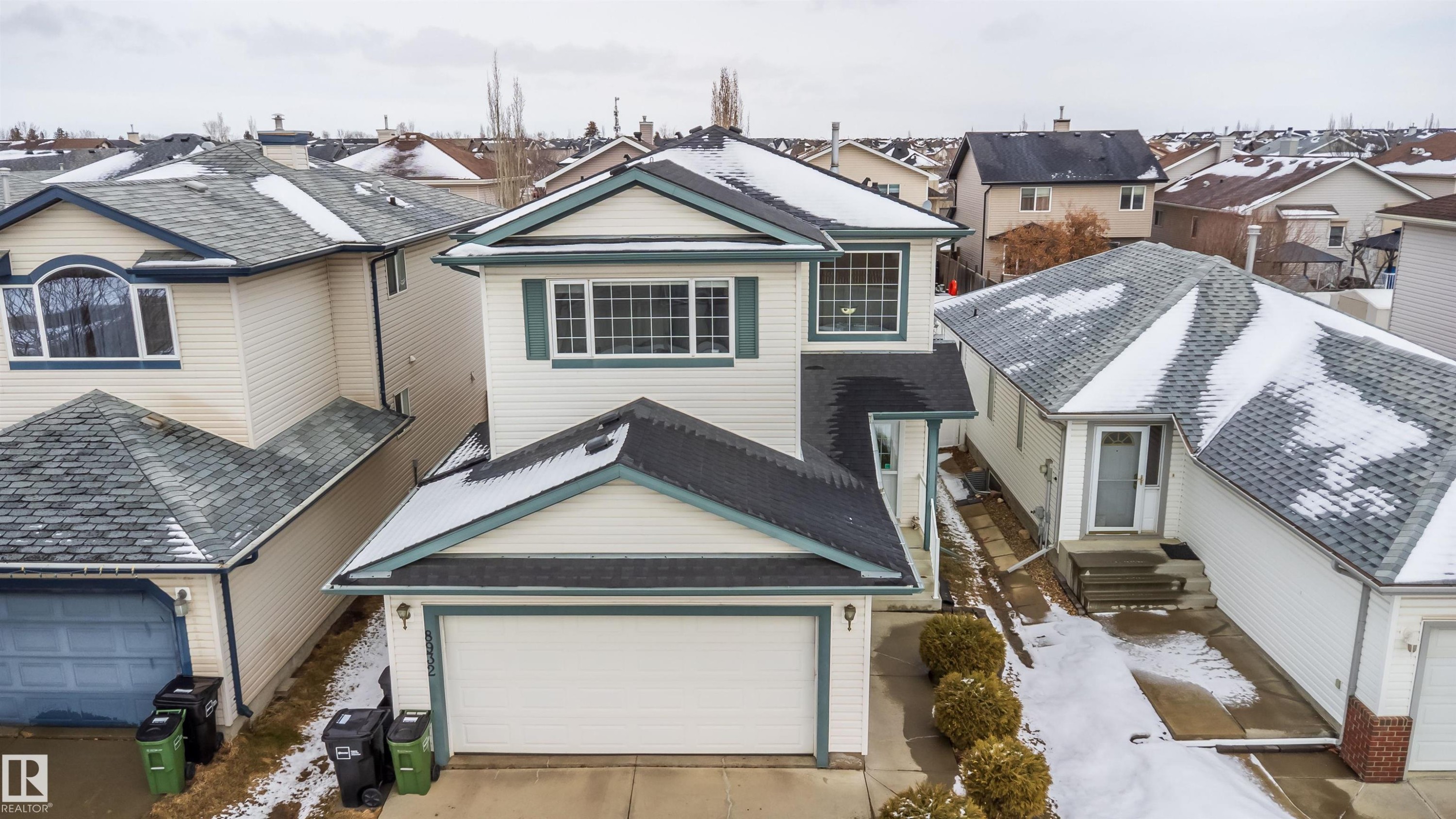 The property features a two-story design with a prominent front-facing garage - 8932 175 Avenue, Edmonton, AB - Outdoor