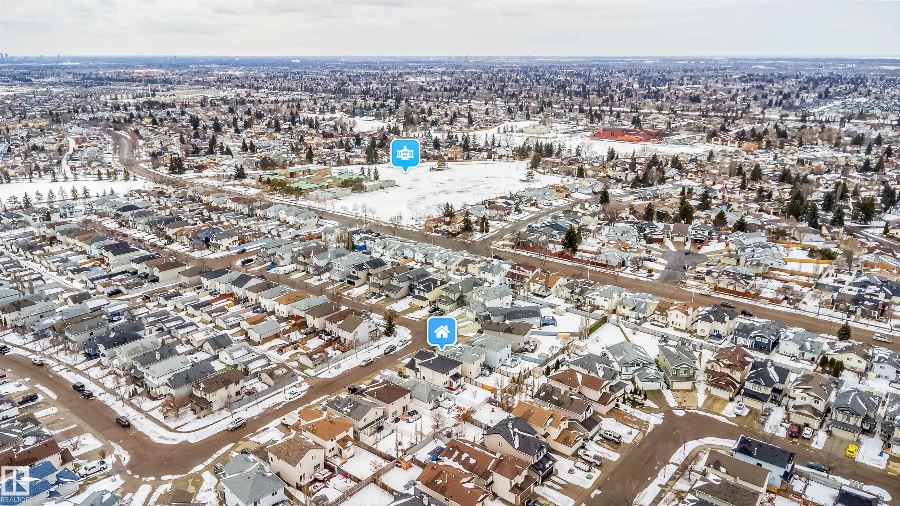 Aerial view of the neighborhood with a residential area in the foreground and a distant city skyline visible - 8932 175 Avenue, Edmonton, AB - Outdoor With View