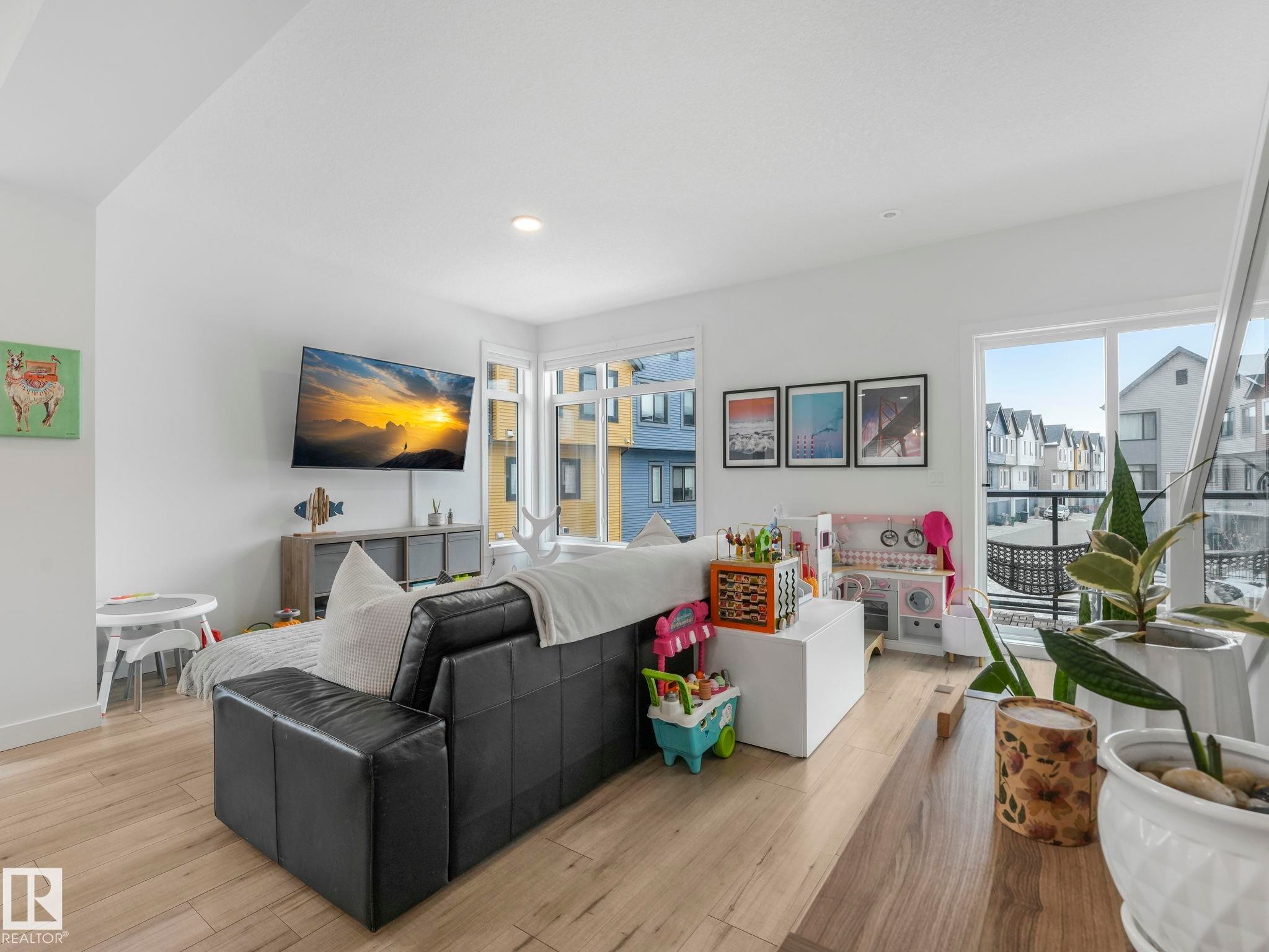 This living area features light wood flooring, white walls, and recessed lighting - 95 1010 Rabbit Hill Road, Edmonton, AB - Indoor Photo Showing Living Room