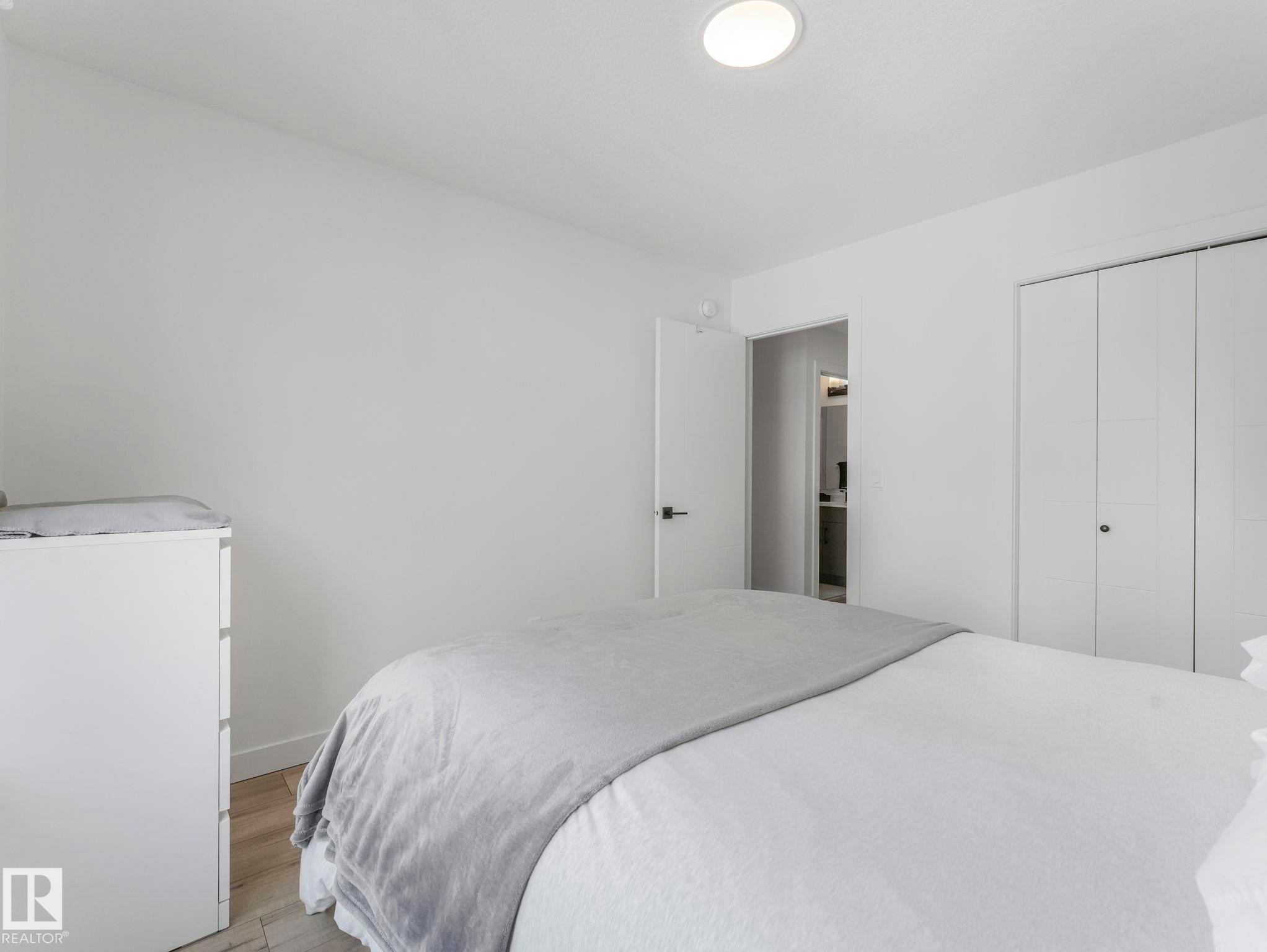 This bright room features light-colored walls, recessed ceiling lighting, and light-toned flooring - 95 1010 Rabbit Hill Road, Edmonton, AB - Indoor Photo Showing Bedroom