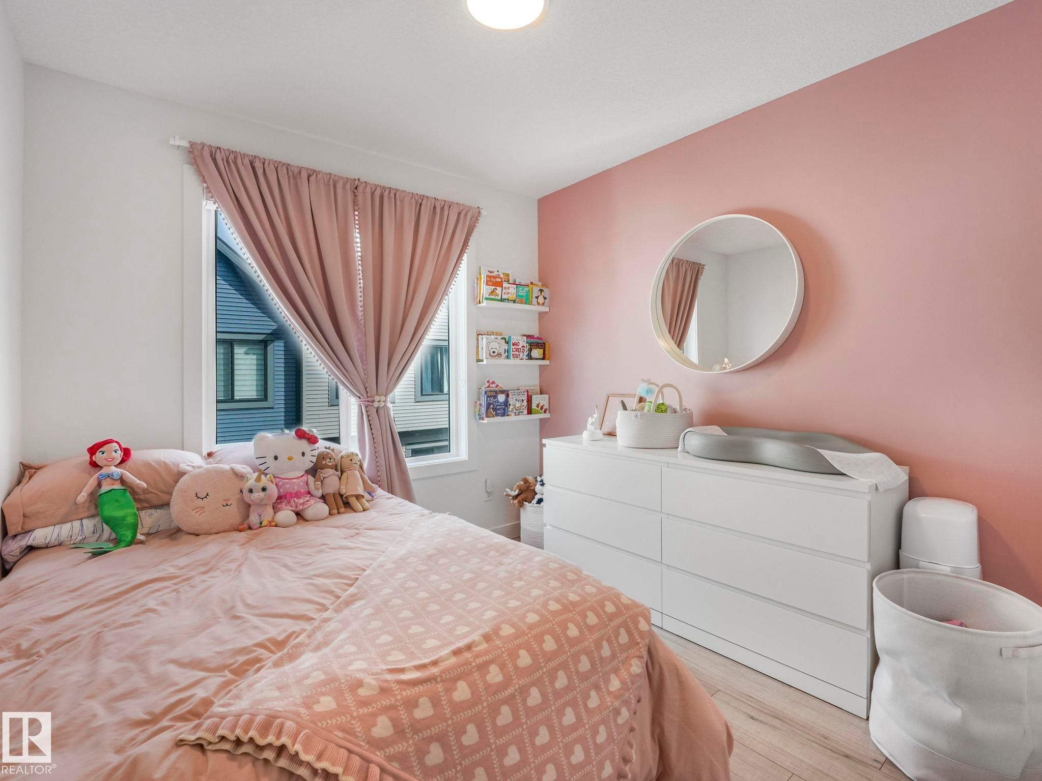 This room features a window with draped curtains and a light fixture on the ceiling - 95 1010 Rabbit Hill Road, Edmonton, AB - Indoor Photo Showing Bedroom