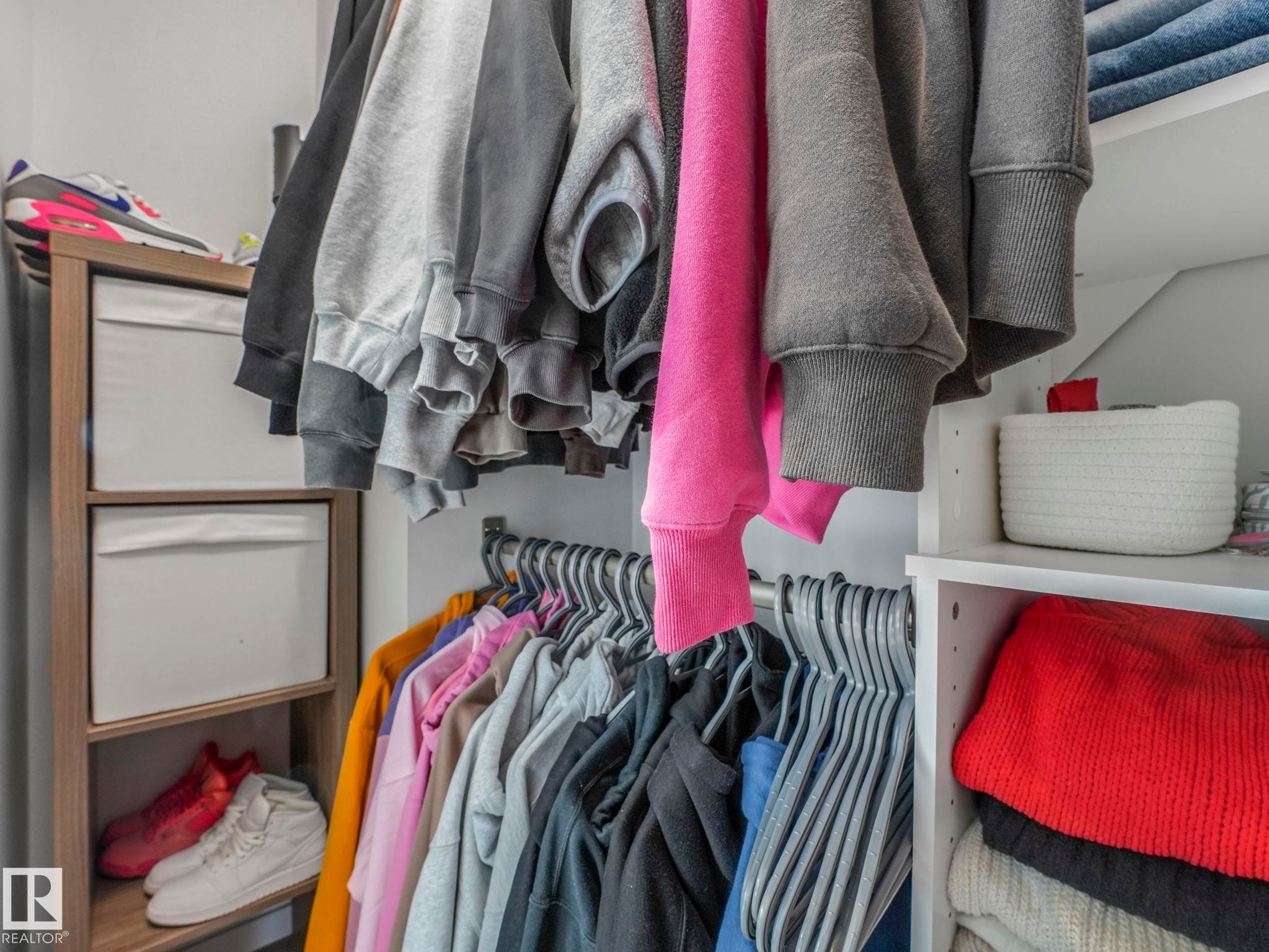 Integrated closet storage system with shelving and hanging rods - 95 1010 Rabbit Hill Road, Edmonton, AB - Indoor With Storage
