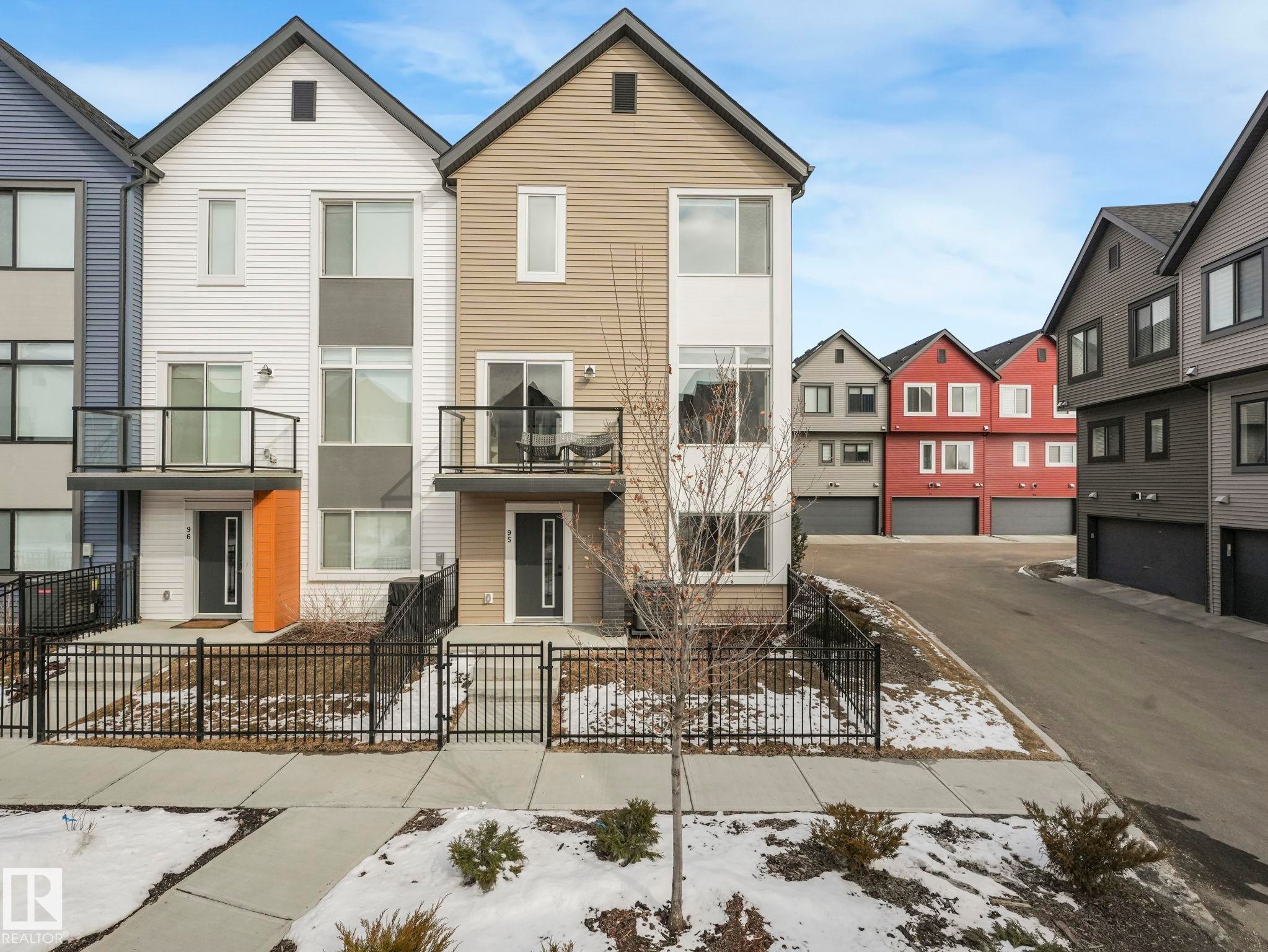 The property features a modern facade with contrasting siding and a private balcony - 95 1010 Rabbit Hill Road, Edmonton, AB - Outdoor With Facade