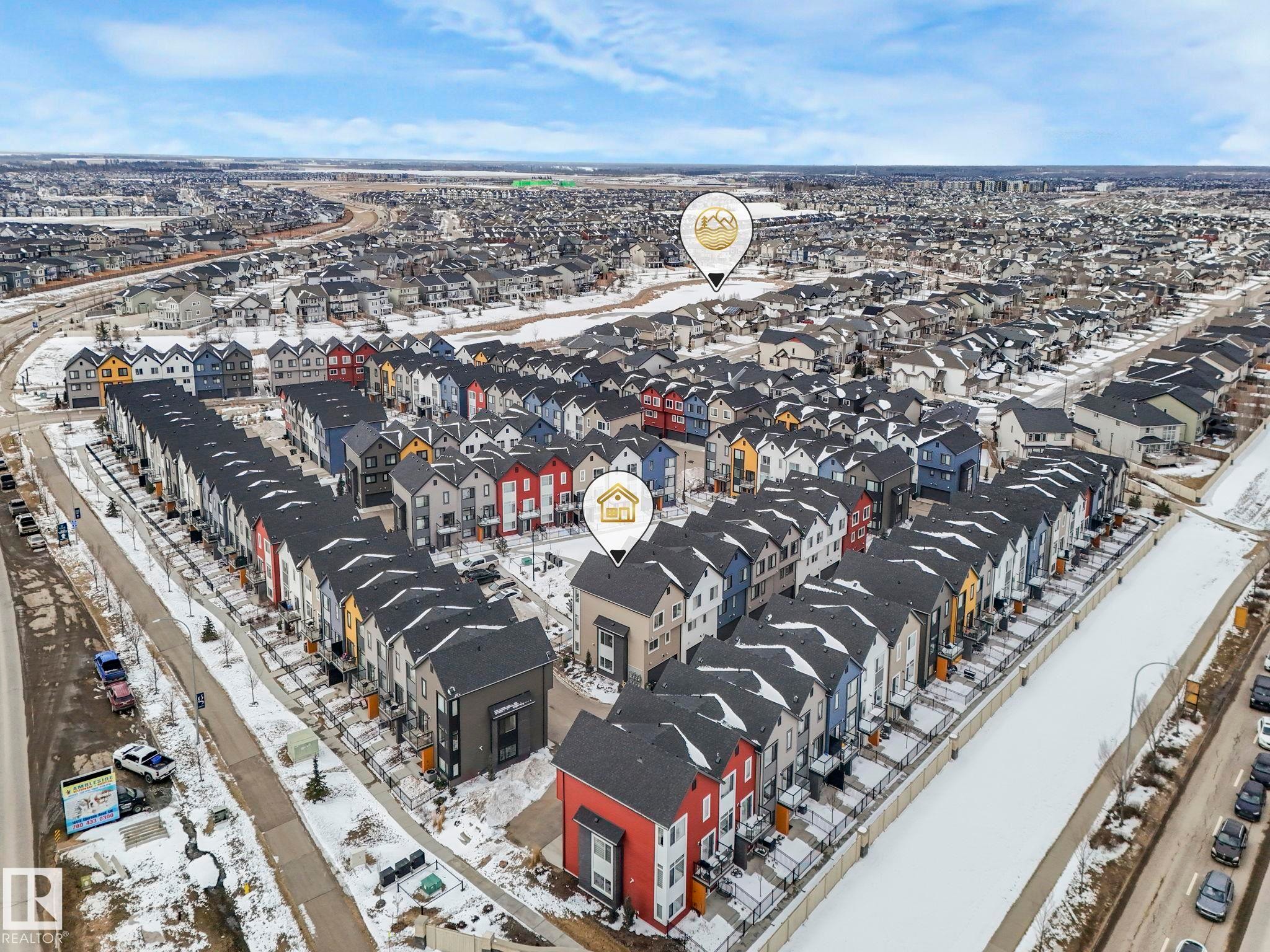 Aerial view showcasing the community with numerous properties featuring varied exterior colors and dark-colored roofs - 95 1010 Rabbit Hill Road, Edmonton, AB - Outdoor With View