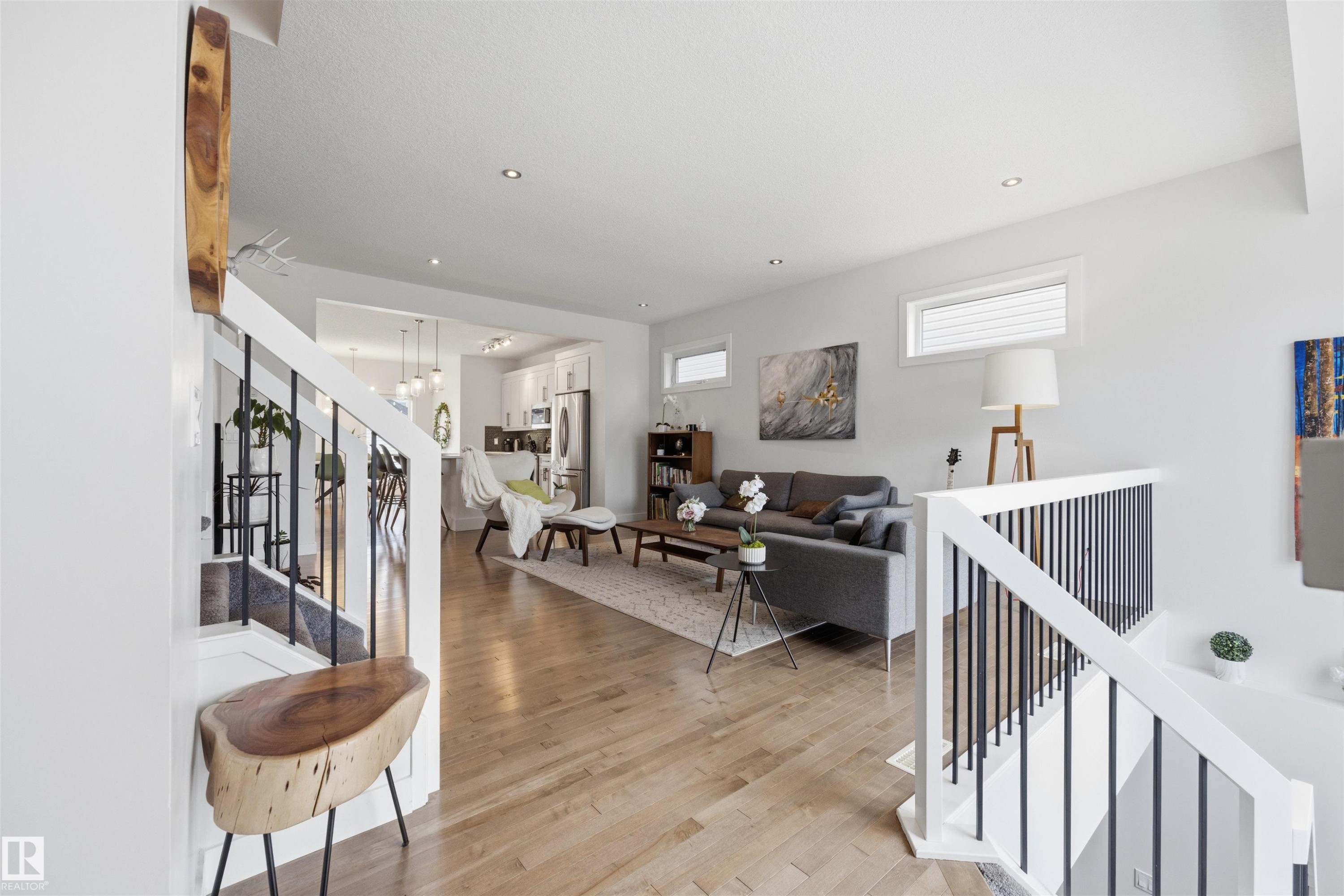 The property features an open living space with hardwood floors and recessed lighting - 7123 Cardinal Way, Edmonton, AB - Indoor Photo Showing Other Room