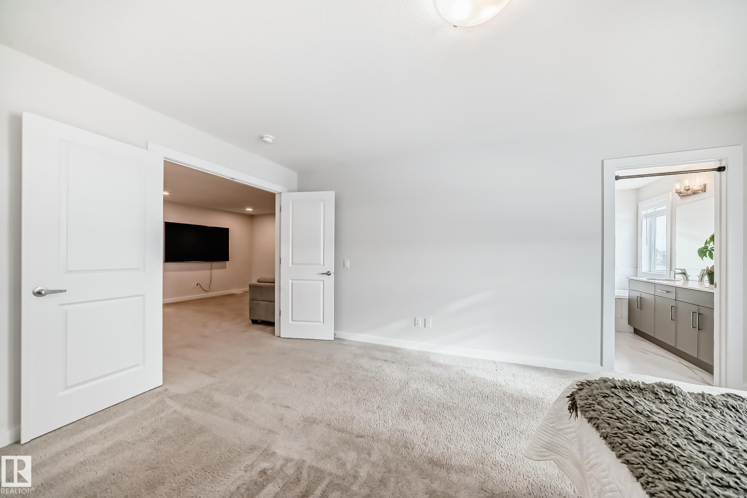 This room features light-colored carpeting, white walls, and bright overhead lighting - 2935 Chokecherry Common, Edmonton, AB - Indoor Photo Showing Other Room