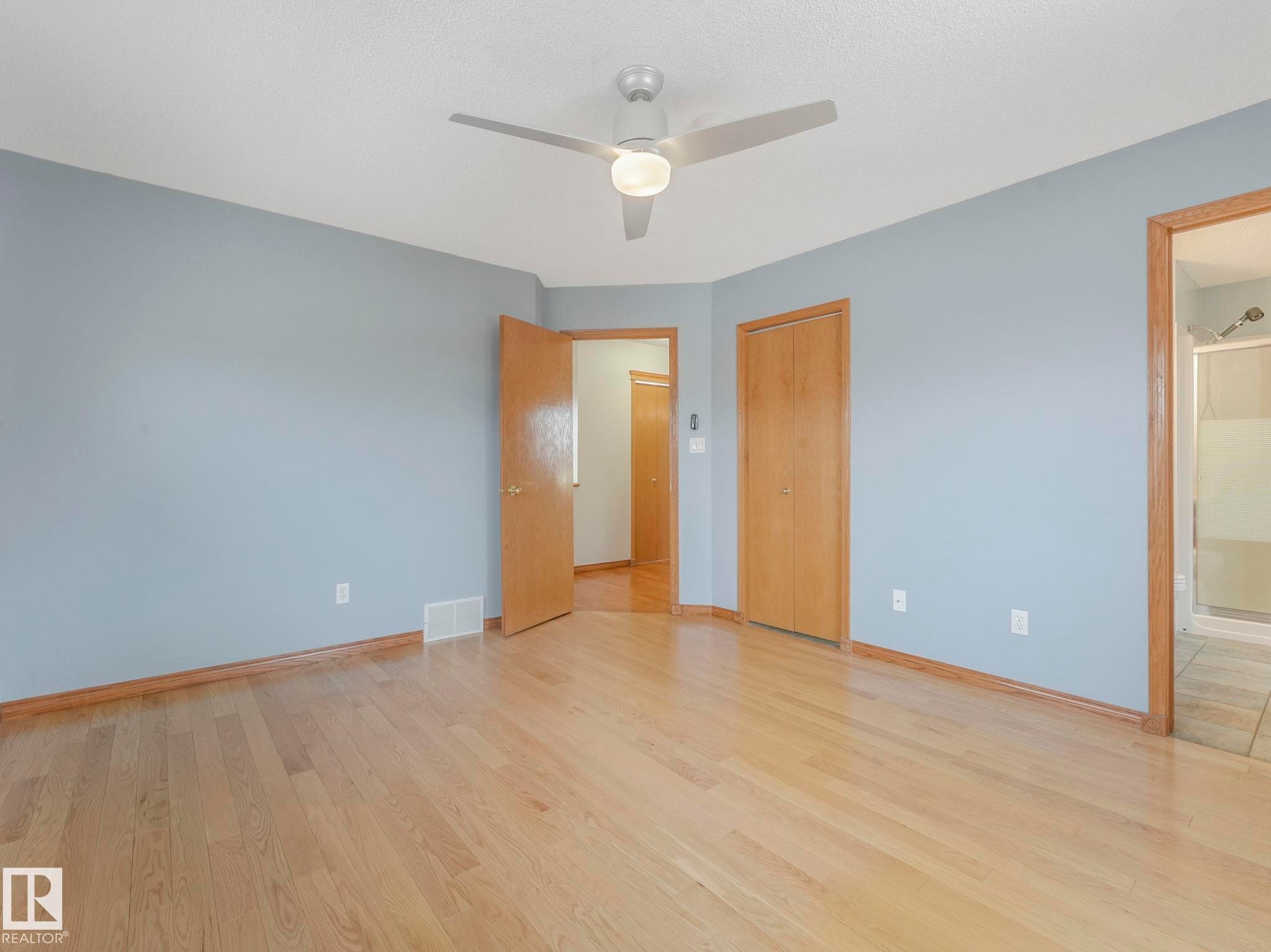 Bright room featuring light wood flooring, light blue walls, and a ceiling fan with integrated lighting - 11704 11 Avenue, Edmonton, AB - Indoor Photo Showing Other Room