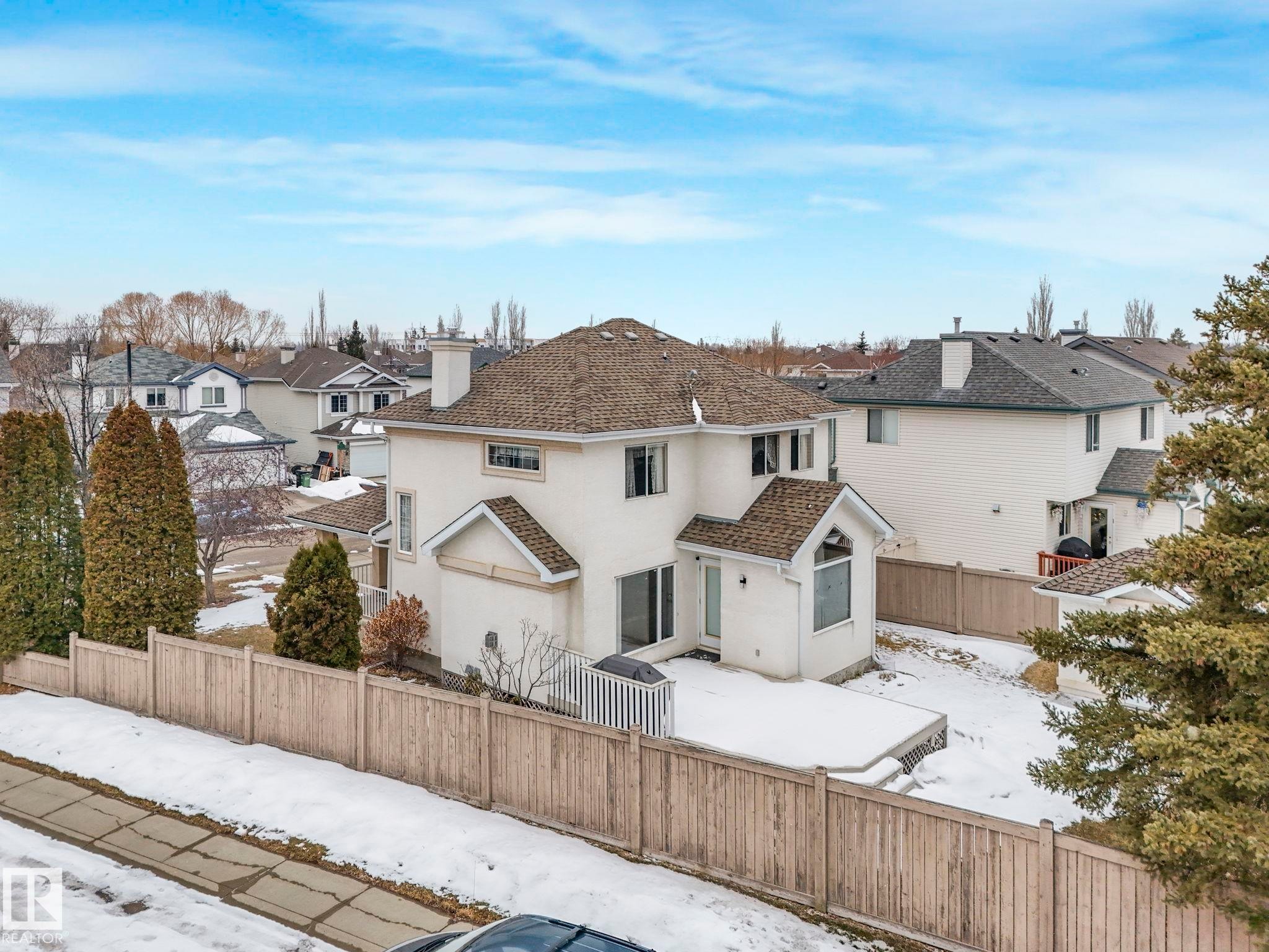The property features a private fenced yard with a deck, offering a versatile outdoor space - 11704 11 Avenue, Edmonton, AB - Outdoor
