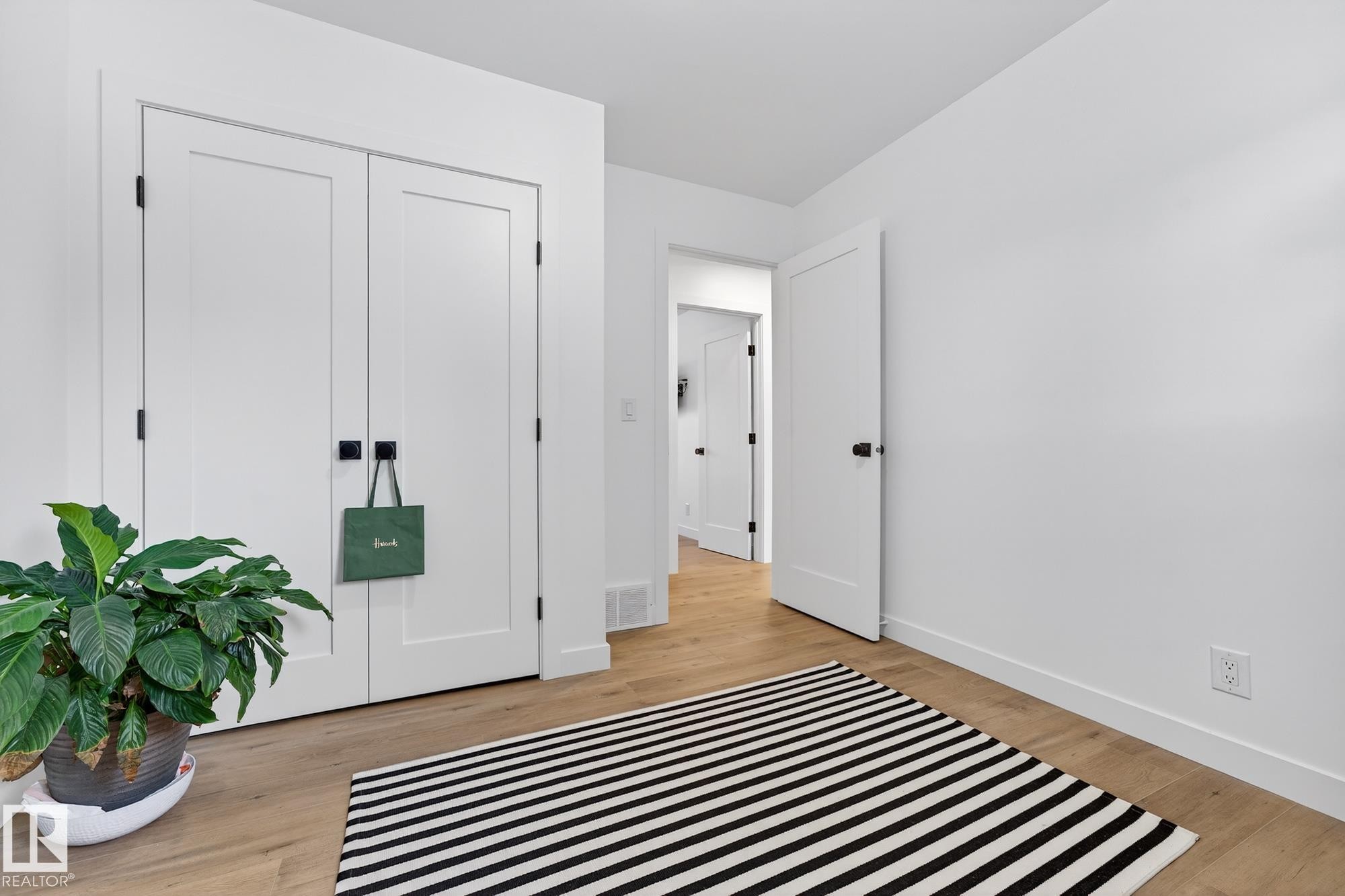 Bedroom with light wood-style floors and a closet - 8604 142 Street, Edmonton, AB - Indoor