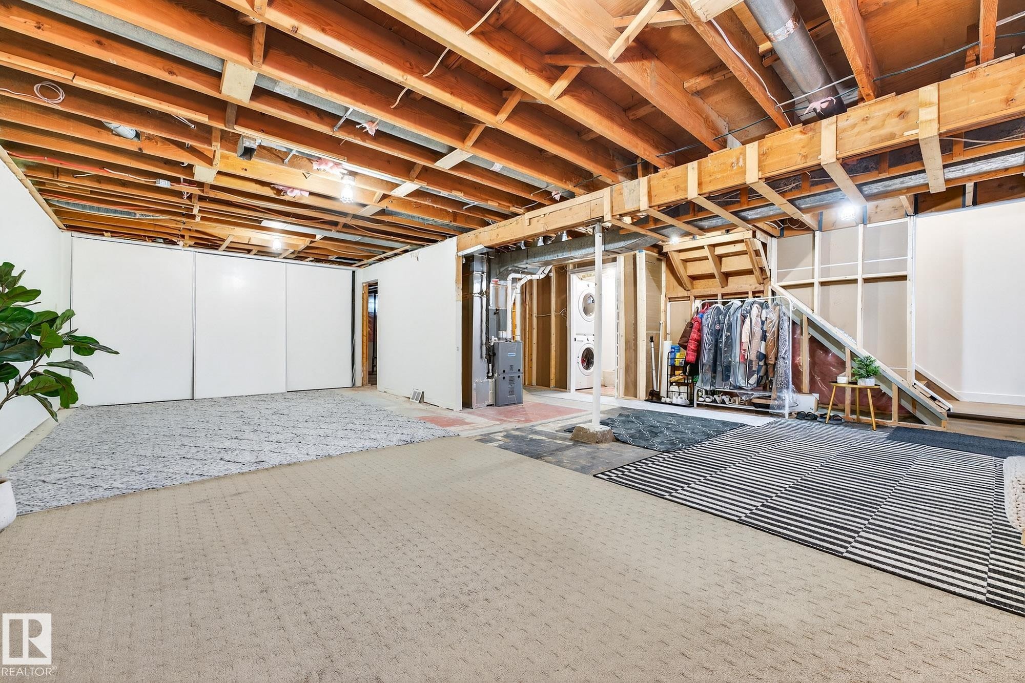 Unfinished basement with washer / clothes dryer and heating unit - 8604 142 Street, Edmonton, AB - Indoor Photo Showing Basement