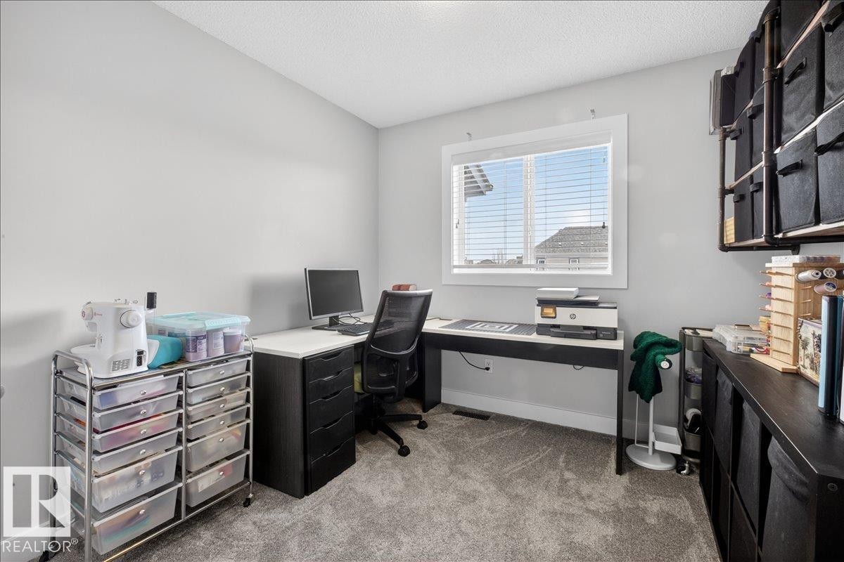 This versatile room features light grey walls, carpeted flooring, and a window with blinds, allowing for natural light - 9034 Rosenthal Link, Edmonton, AB - Indoor Photo Showing Office
