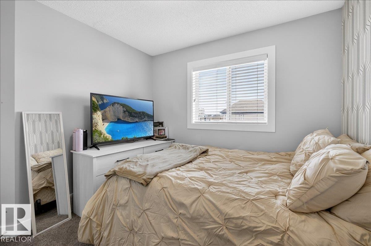 Bedroom featuring light grey walls, a white framed window with blinds, and white trim - 9034 Rosenthal Link, Edmonton, AB - Indoor Photo Showing Bedroom
