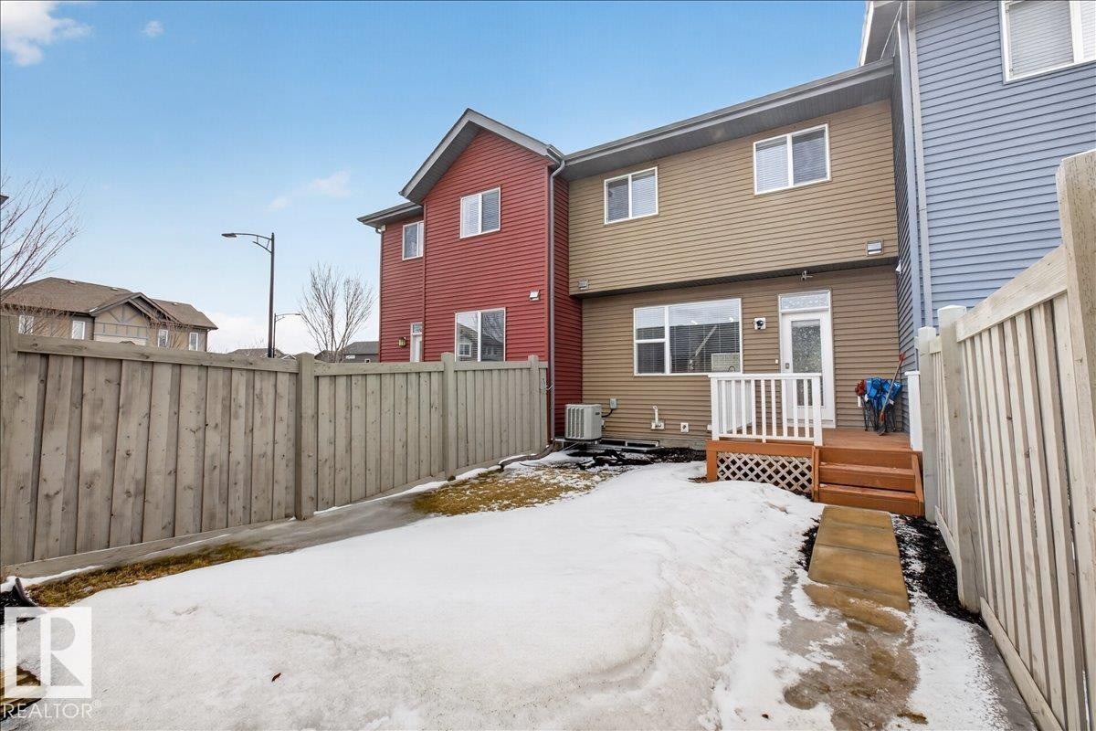 The property includes a fenced rear yard and a deck with stairs - 9034 Rosenthal Link, Edmonton, AB - Outdoor With Deck Patio Veranda With Exterior