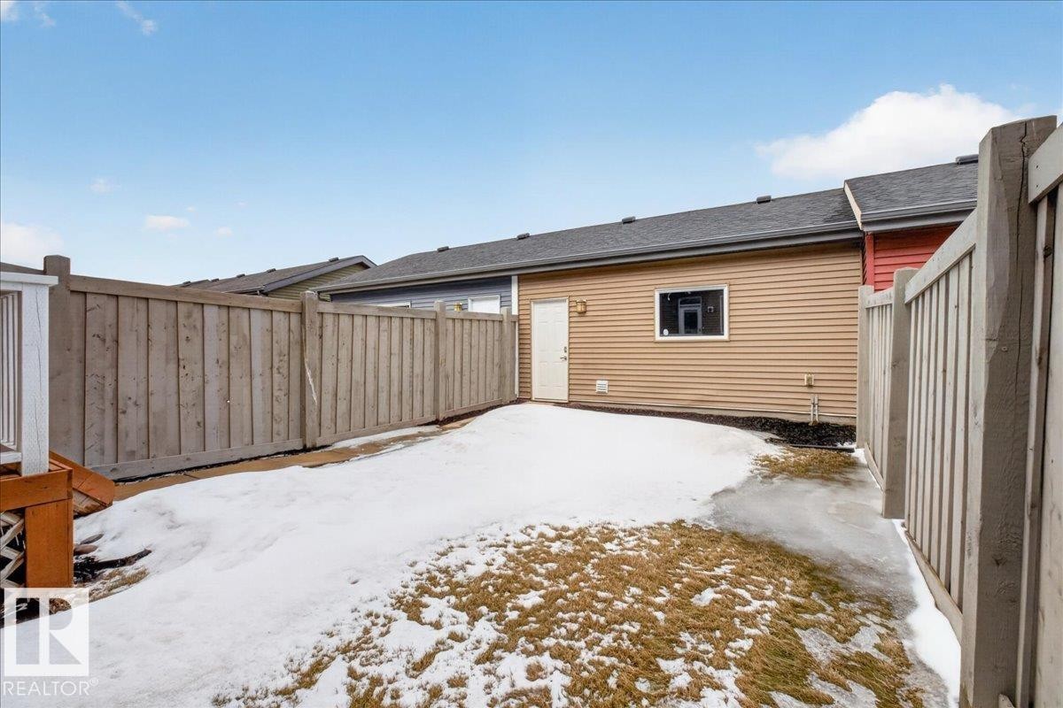 The property features a fenced yard, a rear deck, and a window with trim on the exterior - 9034 Rosenthal Link, Edmonton, AB - Outdoor With Exterior