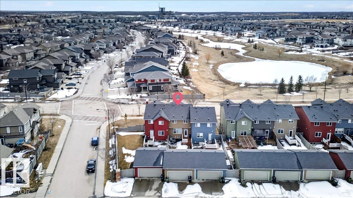 Aerial view showcasing the property within a residential neighborhood featuring detached homes and townhouses - 9034 Rosenthal Link, Edmonton, AB - Outdoor With View
