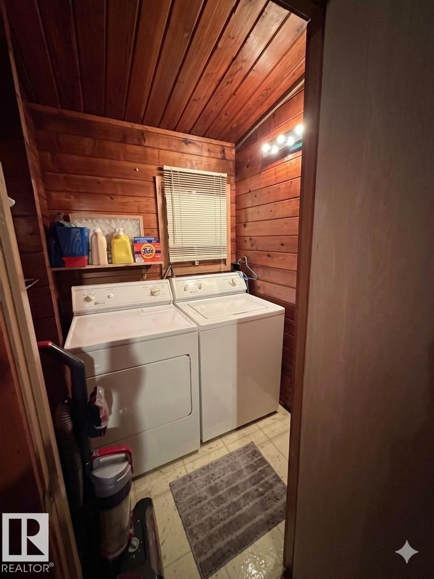 Utility area featuring wood paneling throughout, a window with blinds, and built-in overhead lighting - 1040 &1040 A&B Mitchell Beach Beach, Rural Leduc County, AB