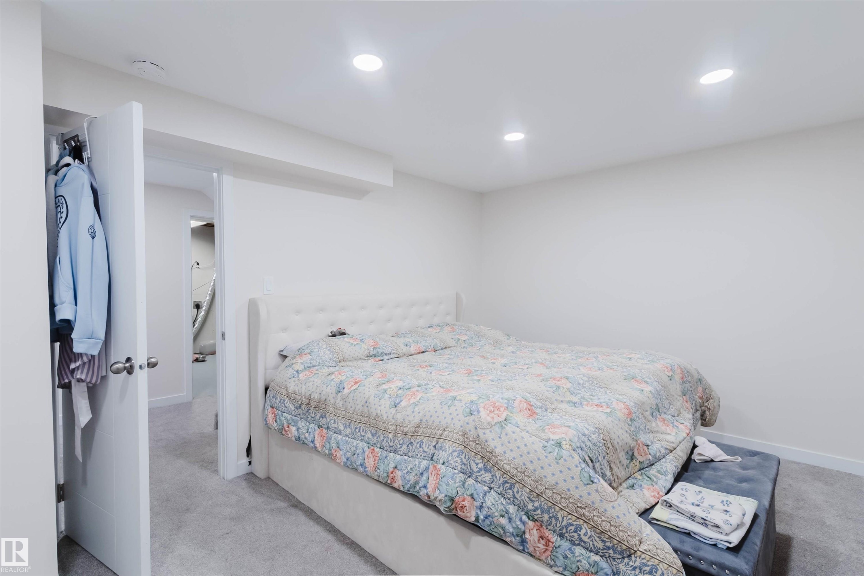 The property features a room with light-colored carpeting and recessed lighting - 18088 93 Avenue Nw, Edmonton, AB - Indoor Photo Showing Bedroom