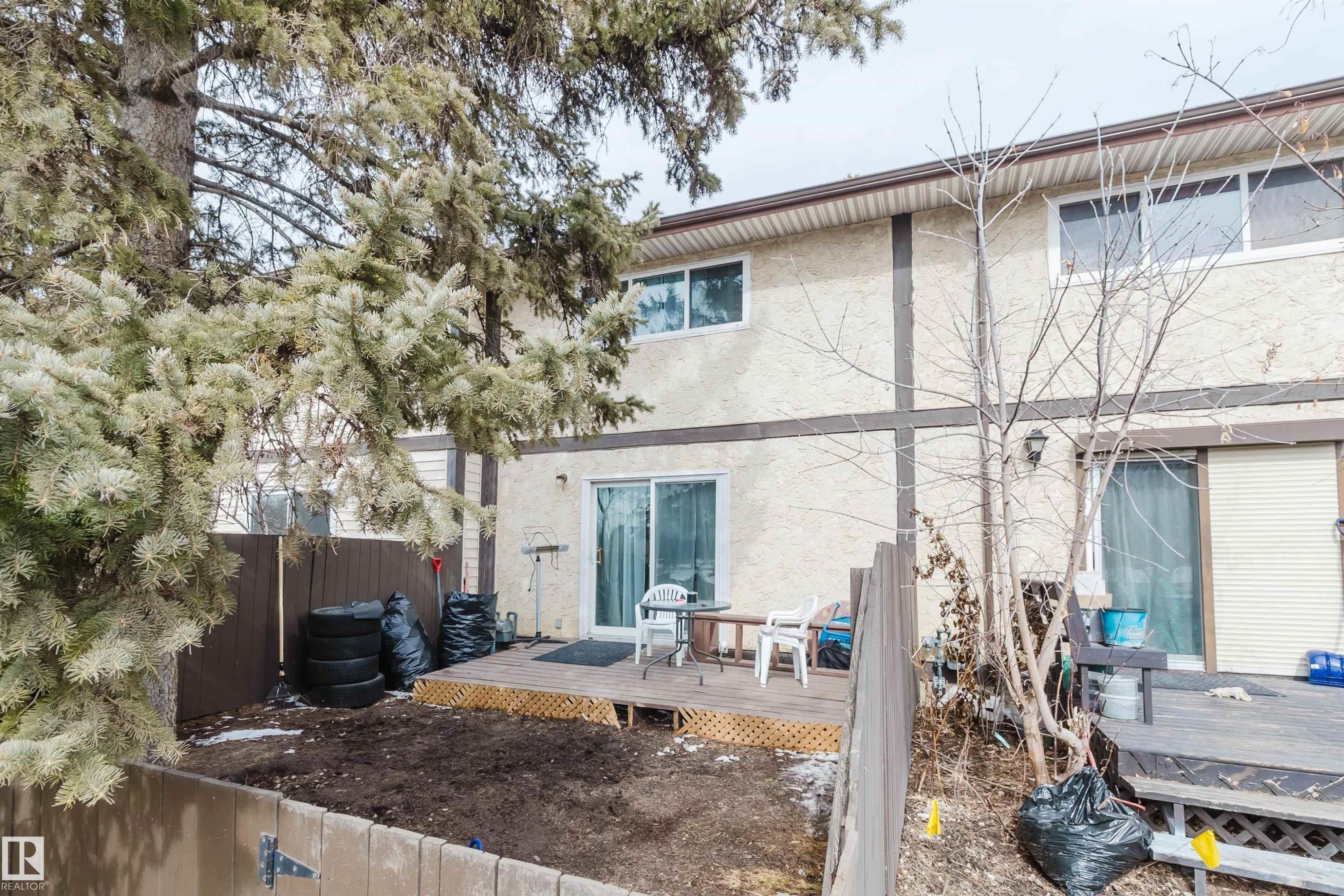 The property features a private fenced yard with a wooden deck - 18088 93 Avenue Nw, Edmonton, AB - Outdoor