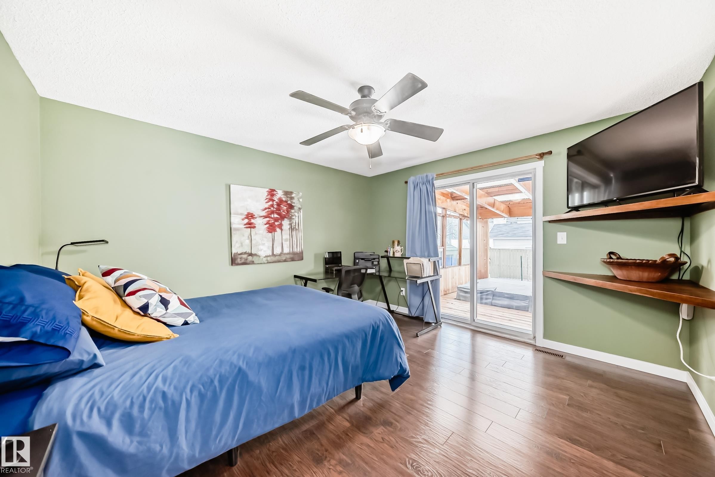 Room featuring hardwood floors, a ceiling fan, and sliding glass doors leading to an outdoor area - 17819 91A Street, Edmonton, AB - Indoor Photo Showing Bedroom