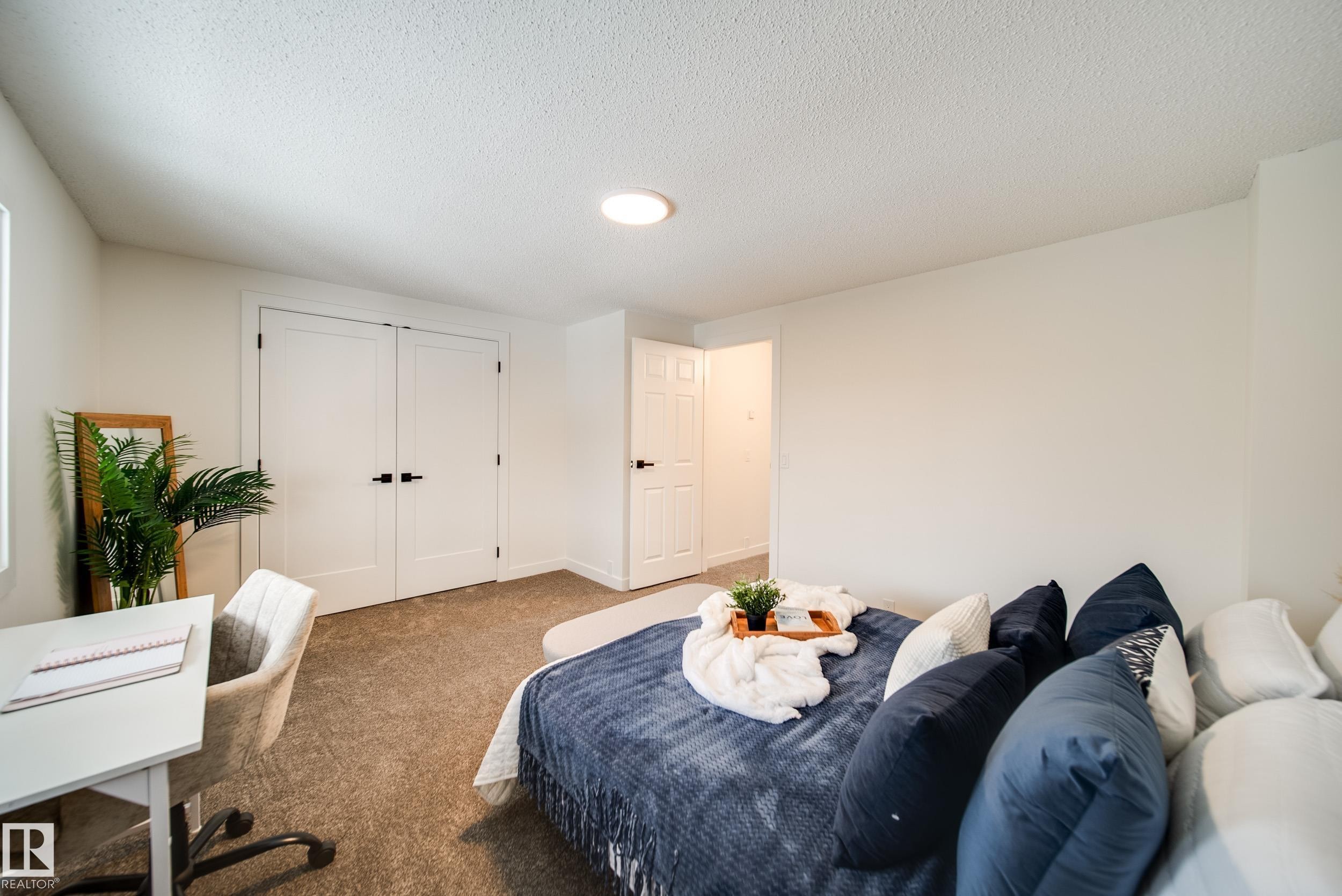 The room features neutral-toned carpet, white walls, and a recessed ceiling light - 125 Woodborough Way, Edmonton, AB - Indoor Photo Showing Bedroom