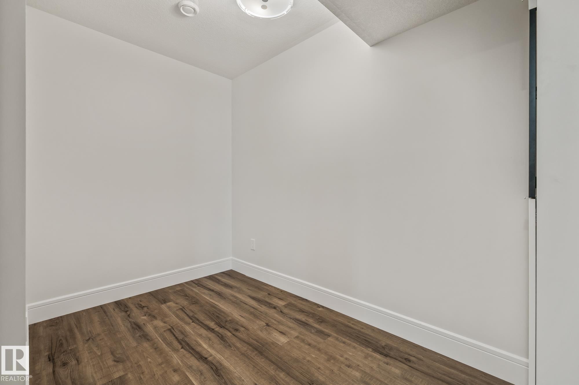 Room featuring light-colored walls, brown flooring, and white baseboards - 3864 Robins Crescent, Edmonton, AB - Indoor Photo Showing Other Room