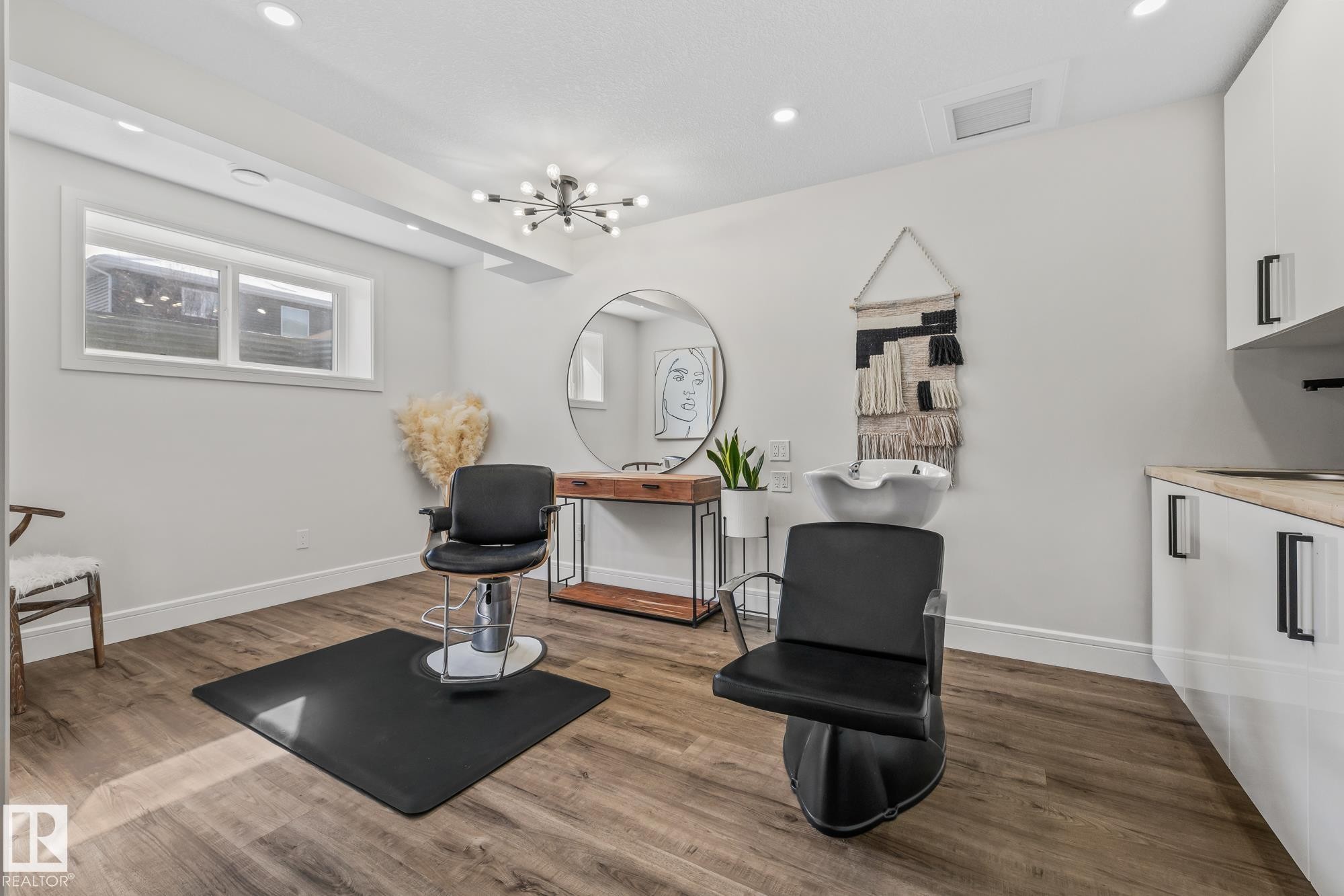 This dedicated space features wood-style flooring, recessed lighting, and a modern light fixture - 3864 Robins Crescent, Edmonton, AB - Indoor