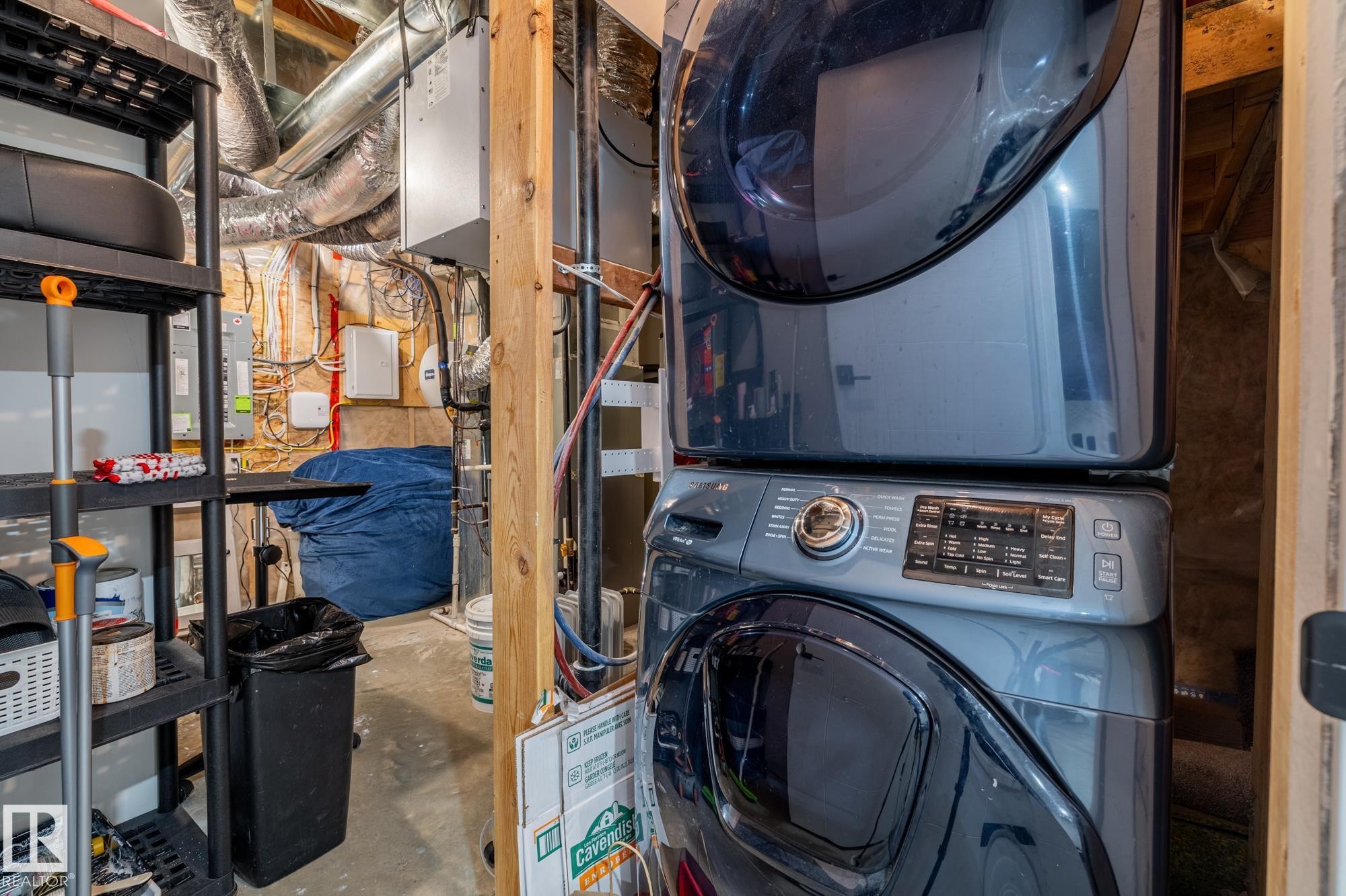 This laundry area features a stacked washer and dryer unit - 3864 Robins Crescent, Edmonton, AB - Indoor Photo Showing Laundry Room