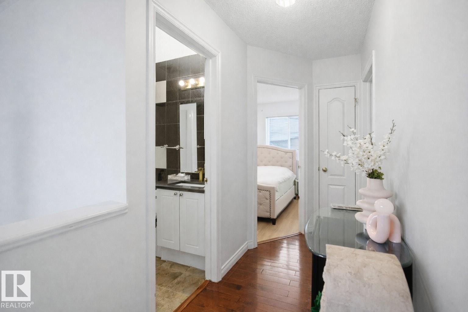 The property features hardwood flooring in the hallway - 4619 202 Street, Edmonton, AB - Indoor