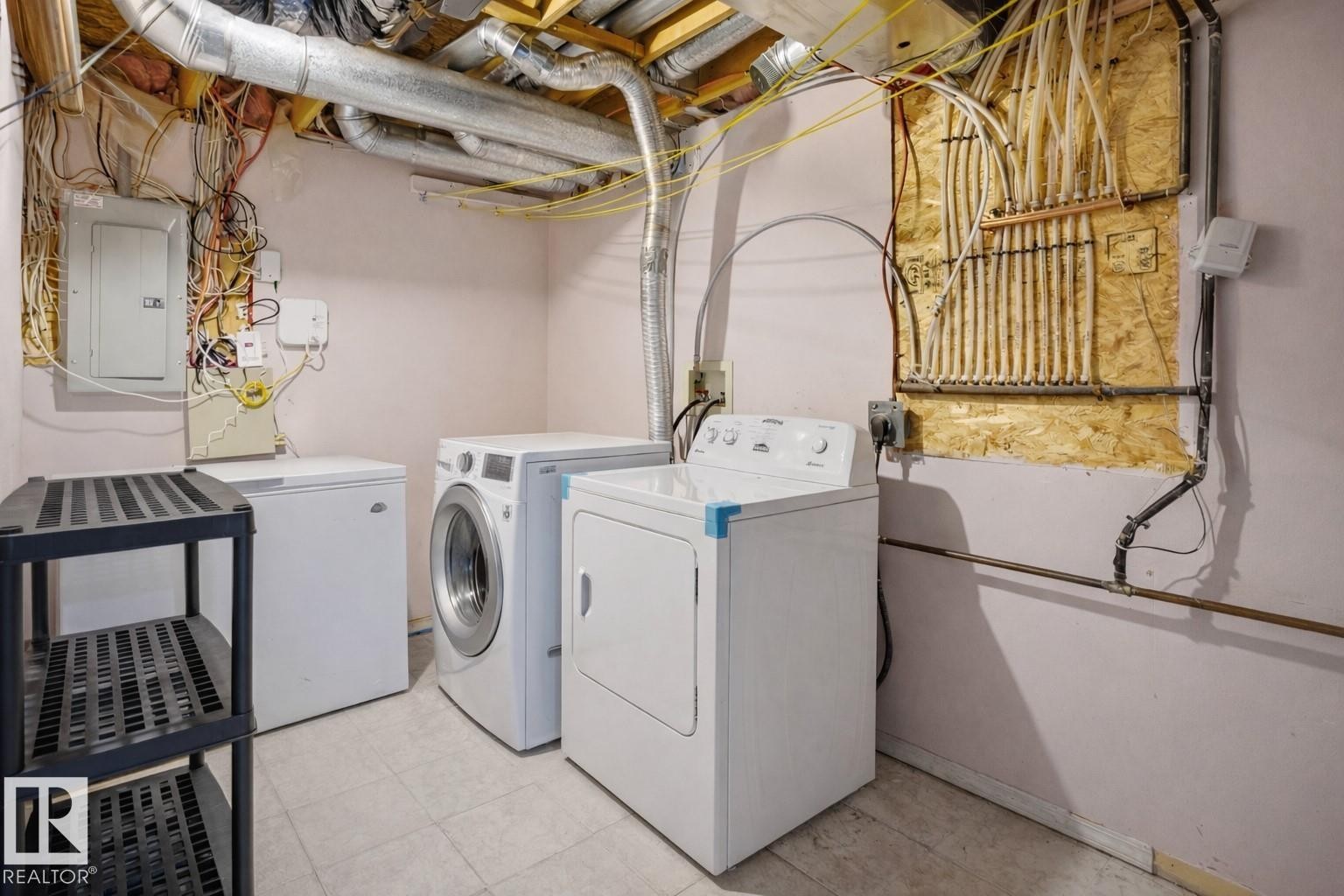 Dedicated laundry area featuring a washer, dryer, and an additional freezer - 4619 202 Street, Edmonton, AB - Indoor Photo Showing Laundry Room