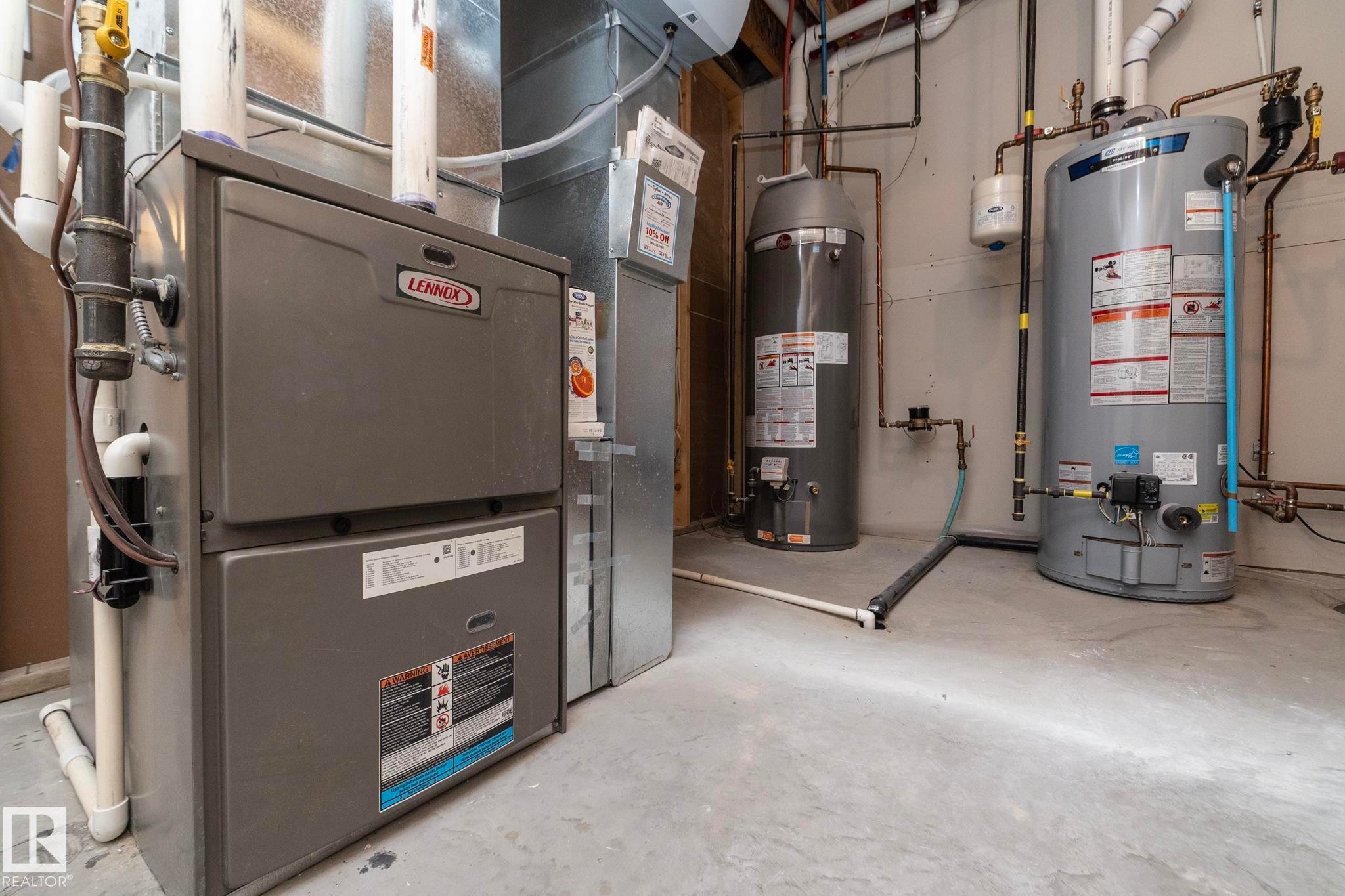 The property features a Lennox furnace and two water heaters, providing essential utilities - 307 Ravine Close, Devon, AB - Indoor Photo Showing Basement