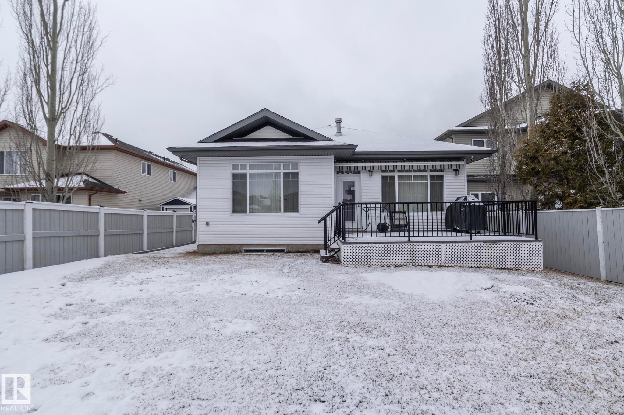 The property features a private fenced yard with a deck - 307 Ravine Close, Devon, AB - Outdoor