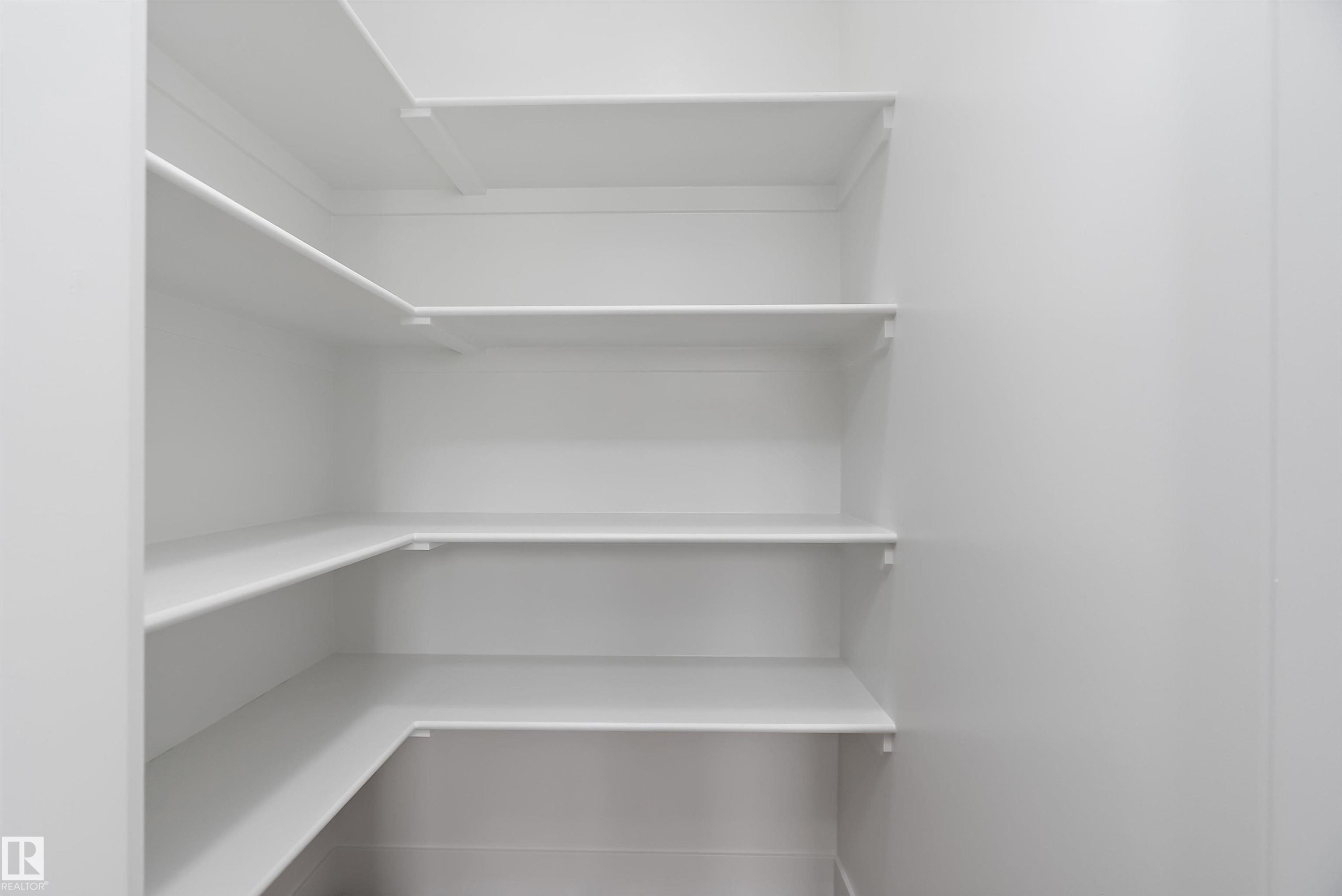 The property features extensive built-in shelving, providing generous storage solutions - 219 Crystal Creek Dr, Leduc, AB - Indoor With Storage